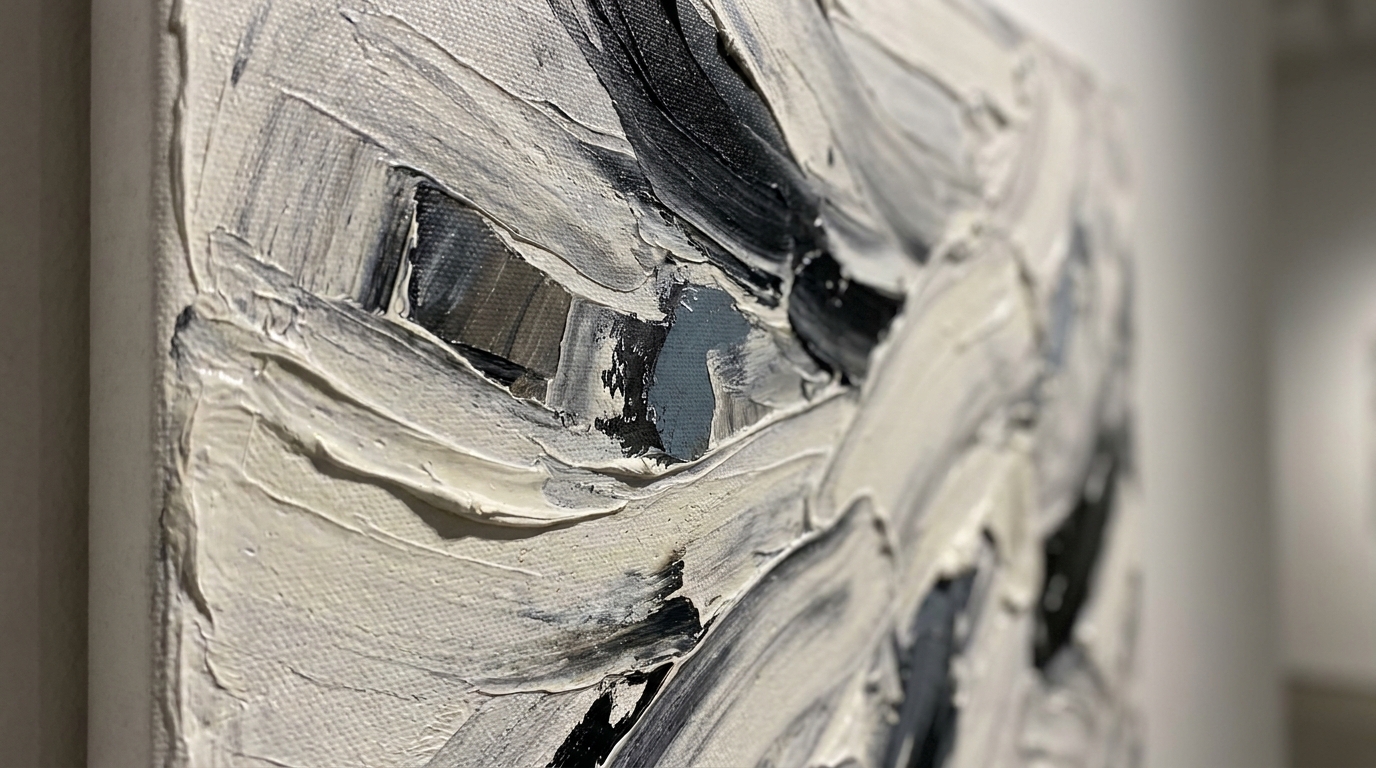 Close-up of thick palette-knife texture in a black, white and grey abstract canvas painting