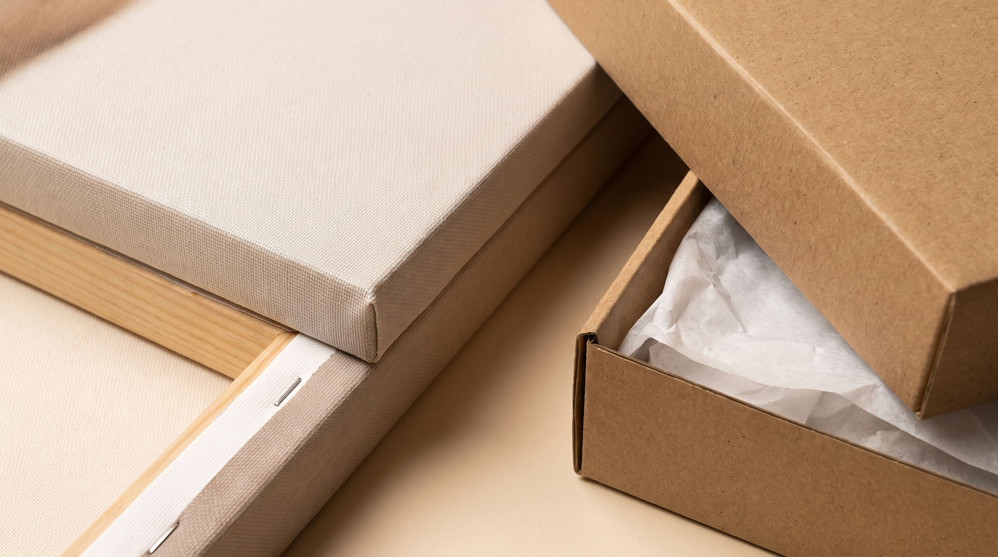 Close-up of a gallery-wrapped canvas corner with wooden stretcher bars and a plain gift box