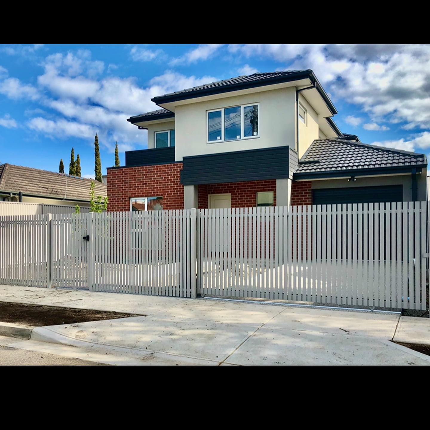 Steel picket fence surrounding front yard