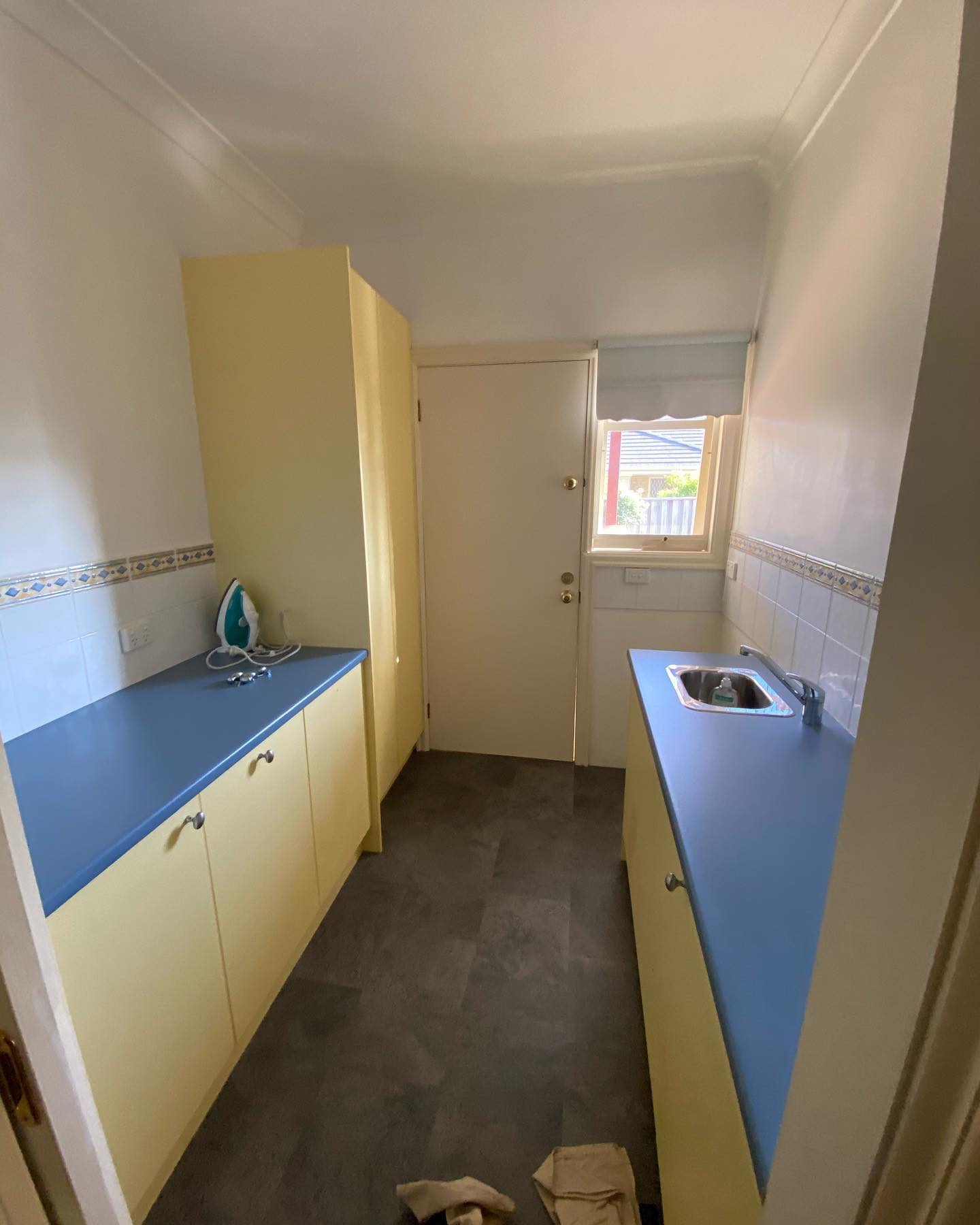 Before image of outdated laundry room