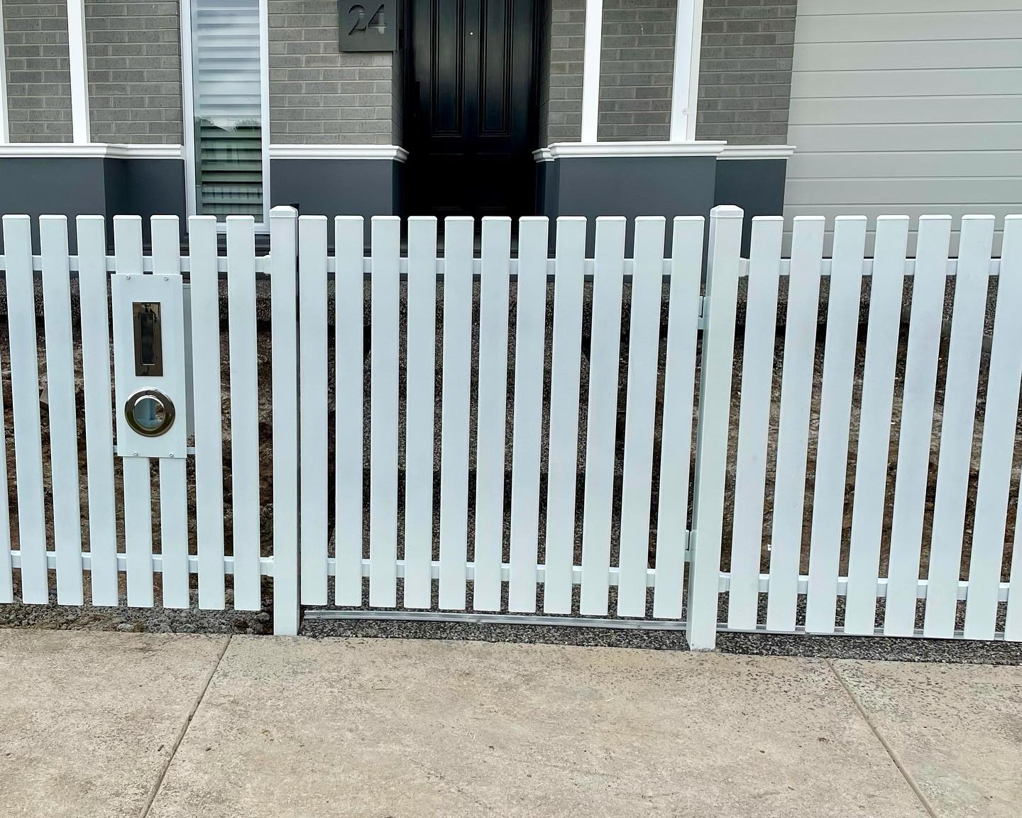 Pedestrian gate integrated into steel picket fence