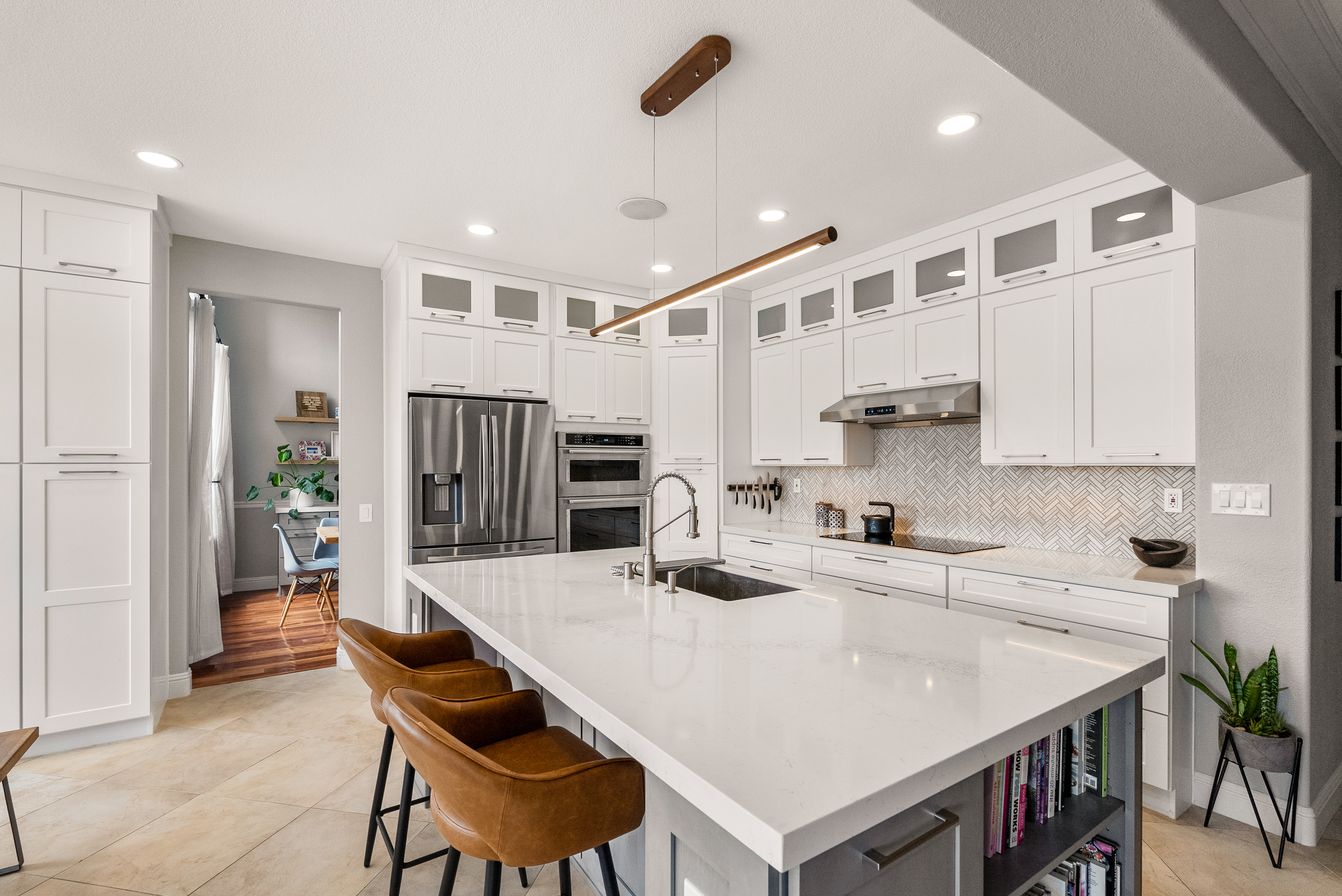 Modern kitchen featuring an island with quartz countertop and stainless steel appliances