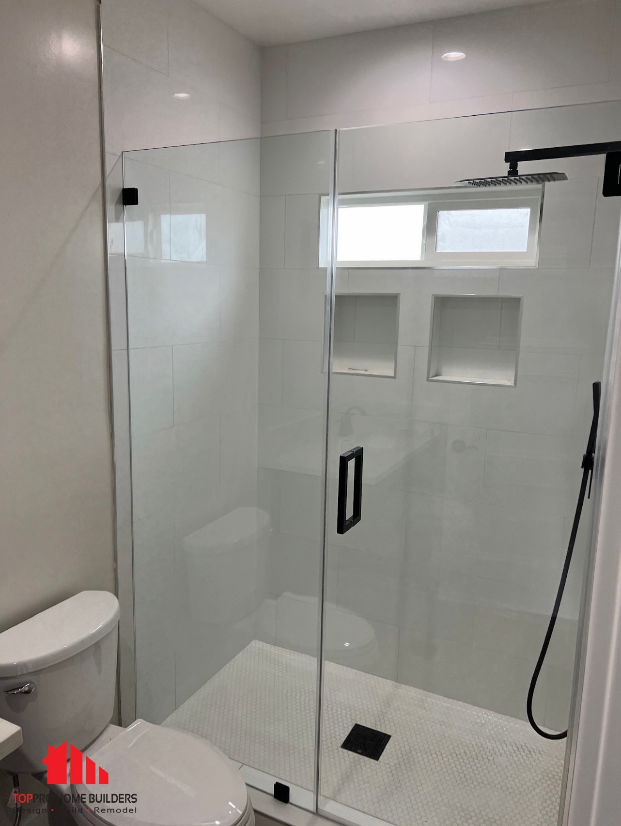 Modern bathroom featuring a glass-enclosed shower with rainfall showerhead