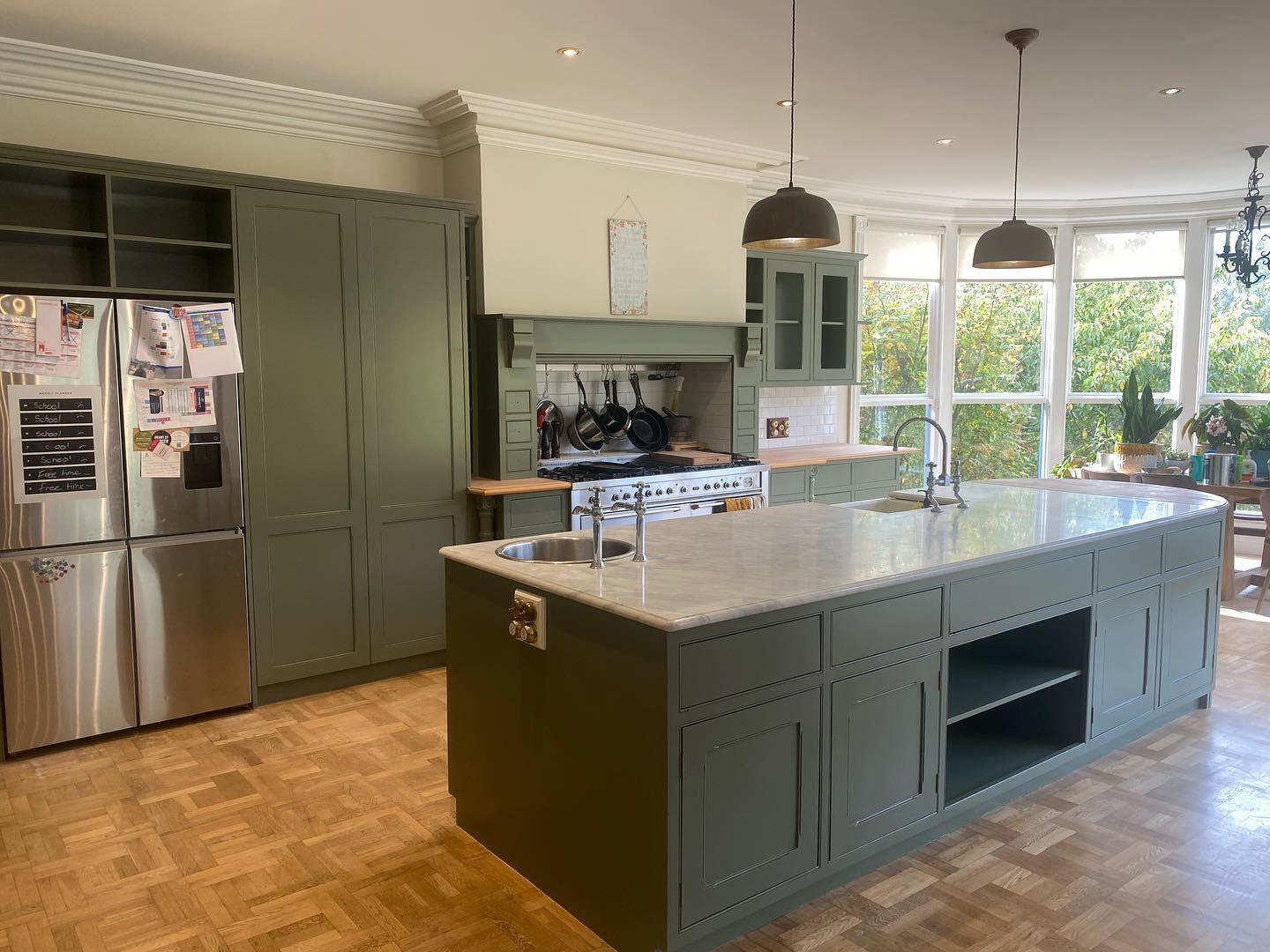 Modernized kitchen with green cabinetry