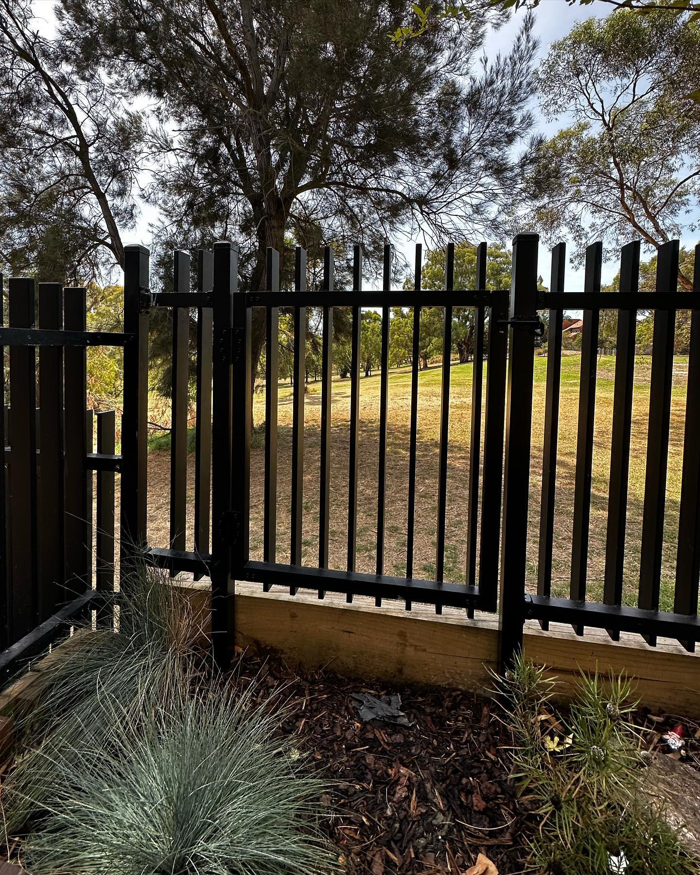 Creating Secure Park Access for a Northcote Townhouse 4 Pedestrian access gate integrated into black metal fence