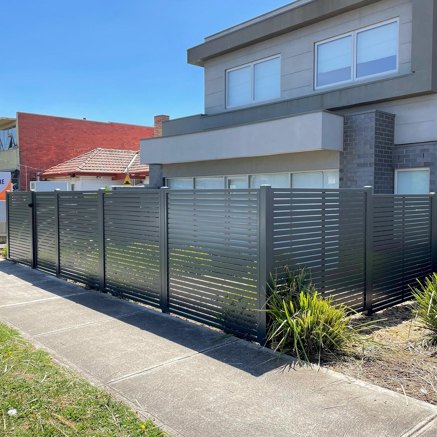 Slat fencing in front of modern residential building