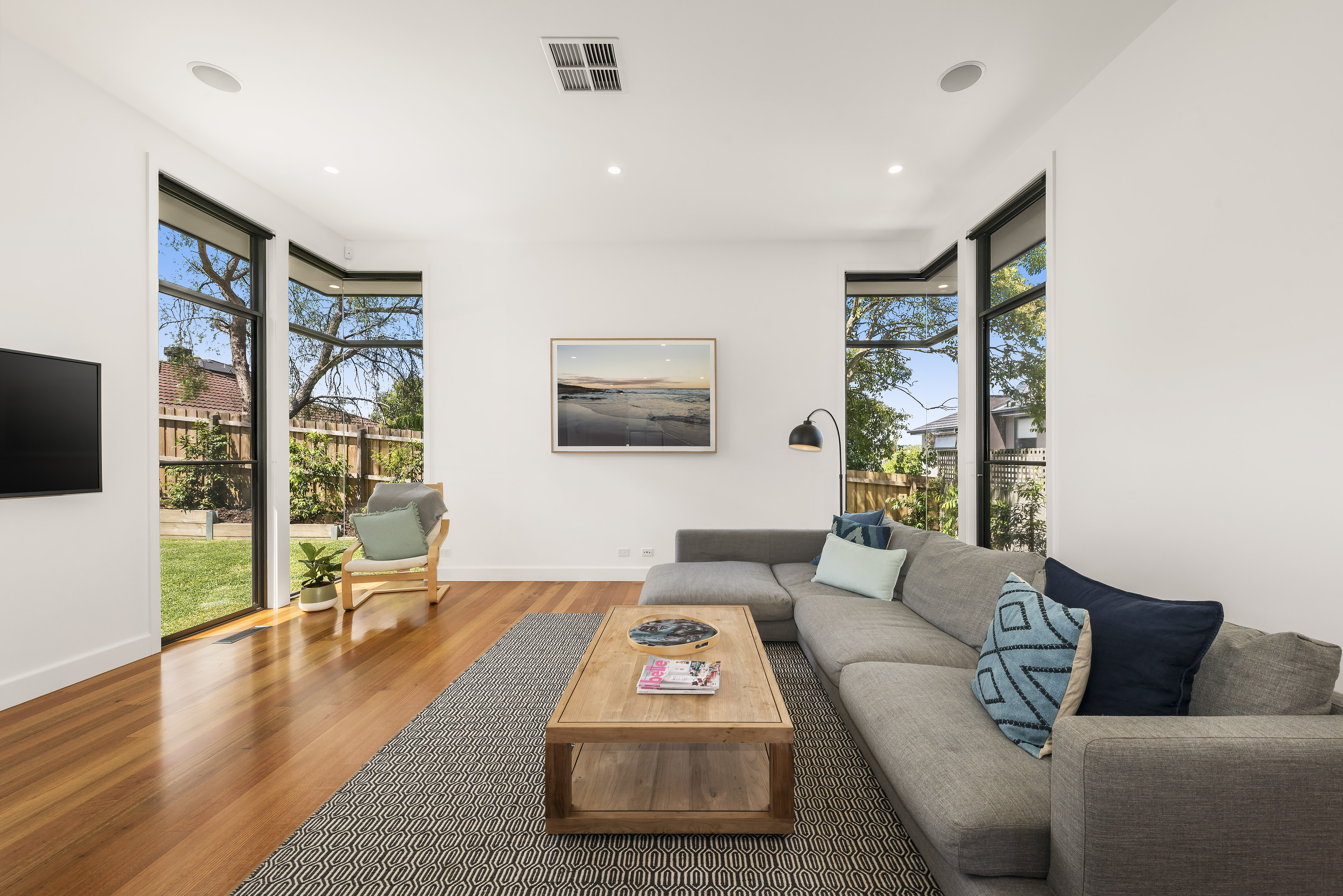Modern living room with large windows allowing natural light