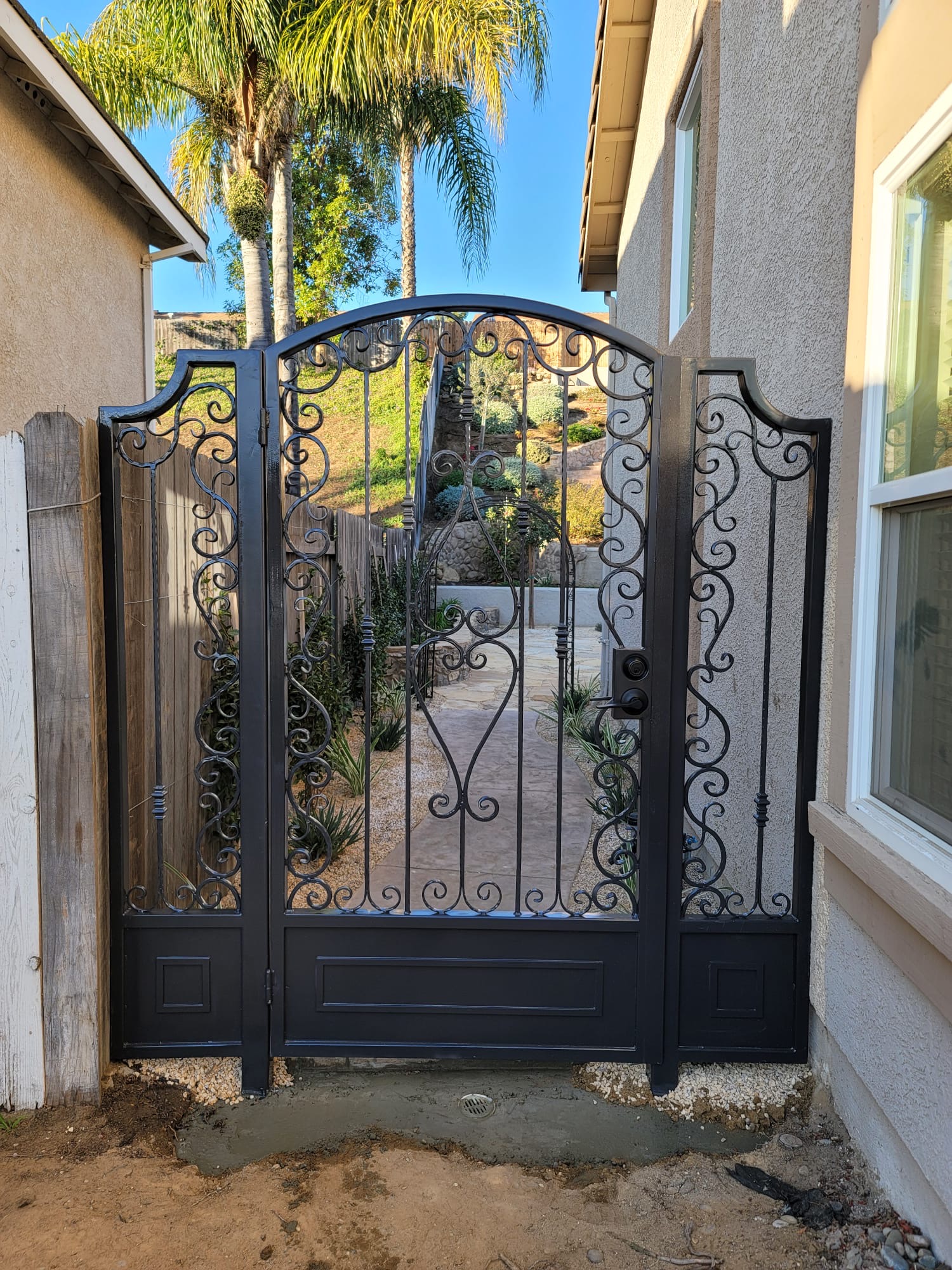 A decorative wrought iron gate featuring intricate scrollwork.