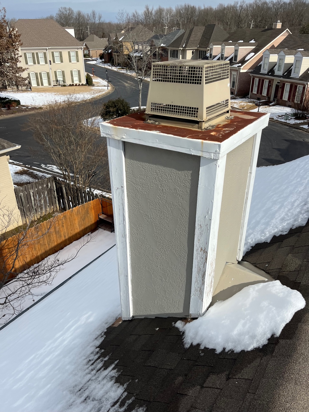 Initial state of the chimney with visible wear and rusted cover