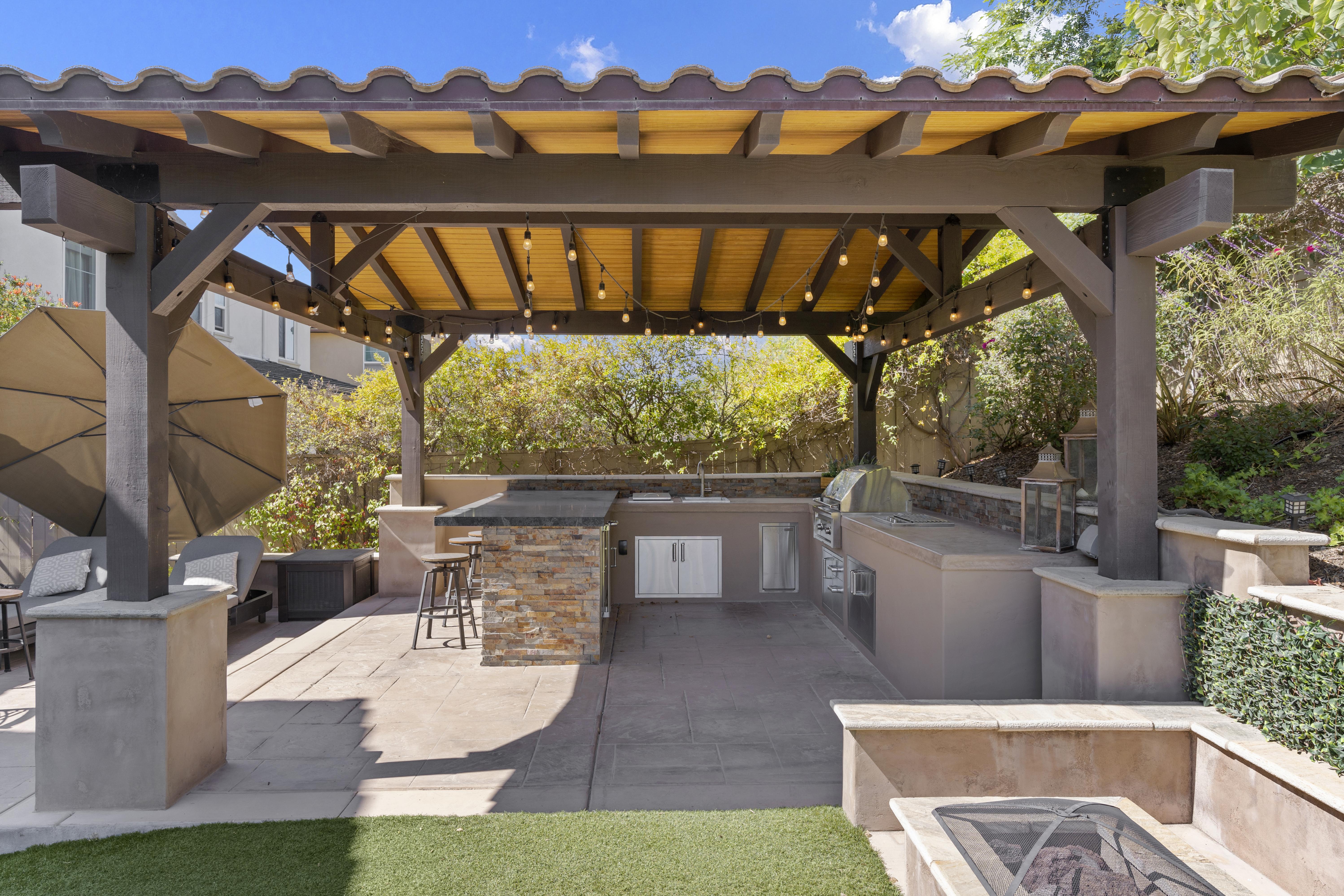 Outdoor kitchen with stone countertop and built-in grill