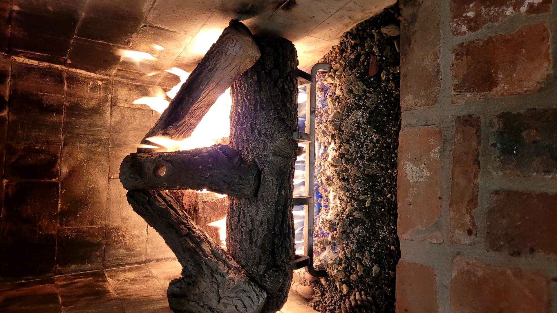 Fireplace with burning logs after restoration