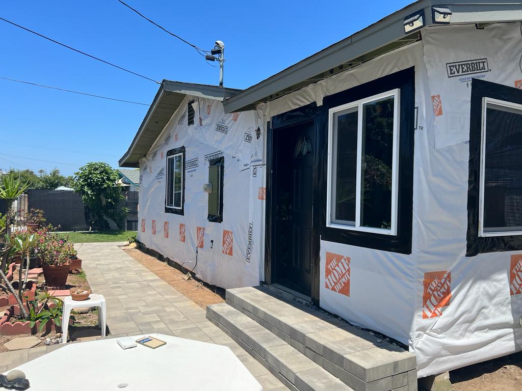 House under renovation wrapped in protective sheathing