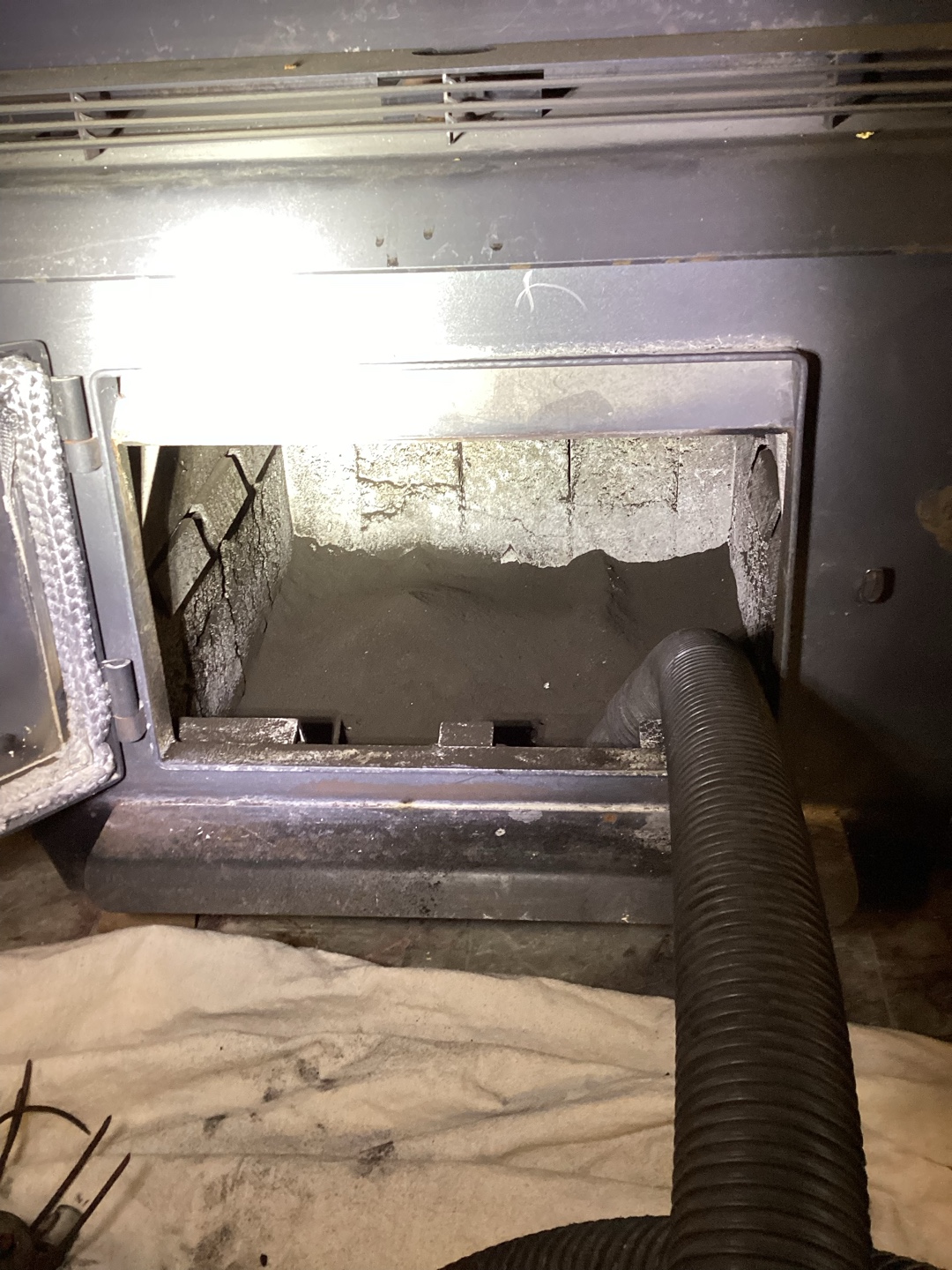Metallic fireplace with tools visible
