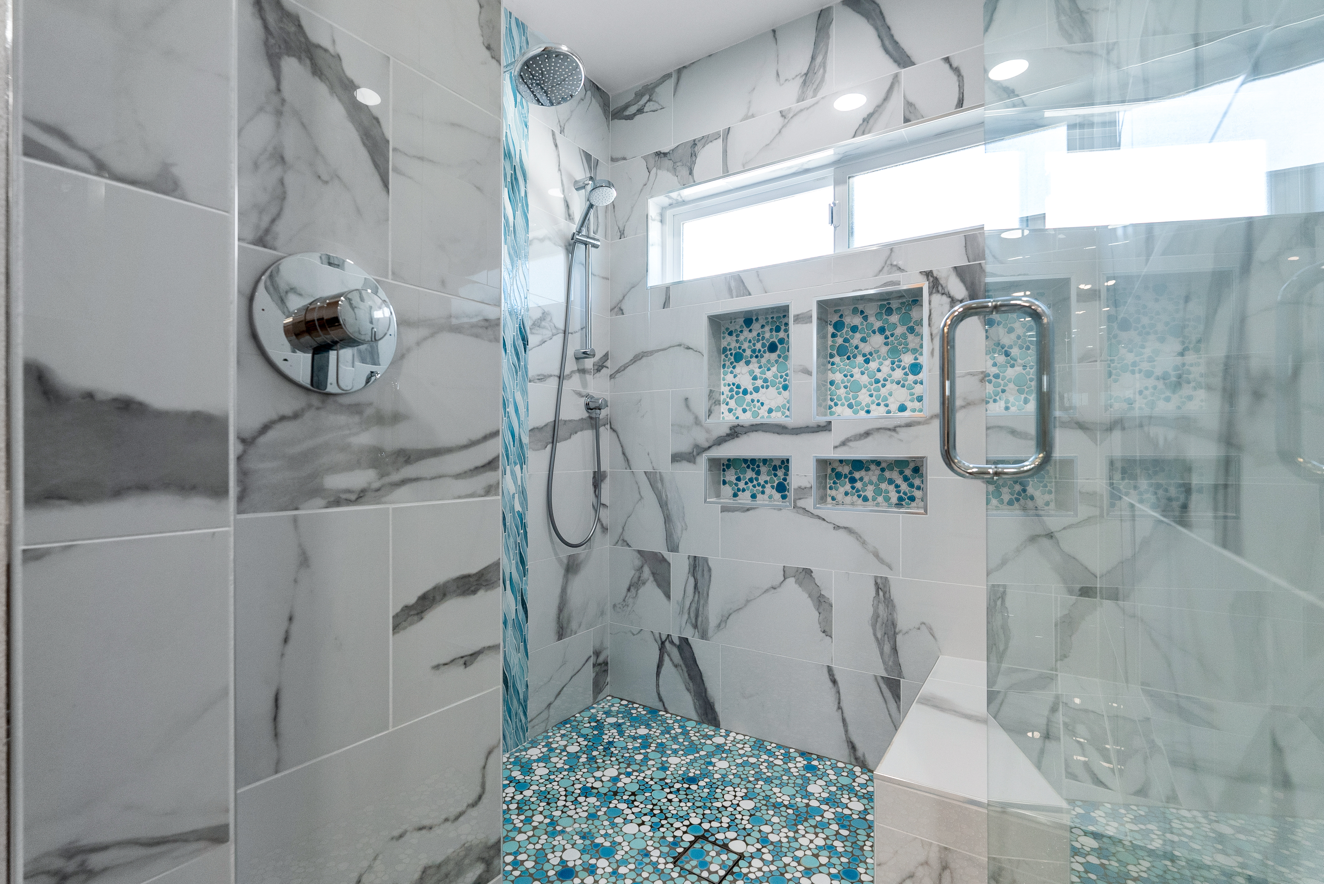 Contemporary shower area with marble tiles