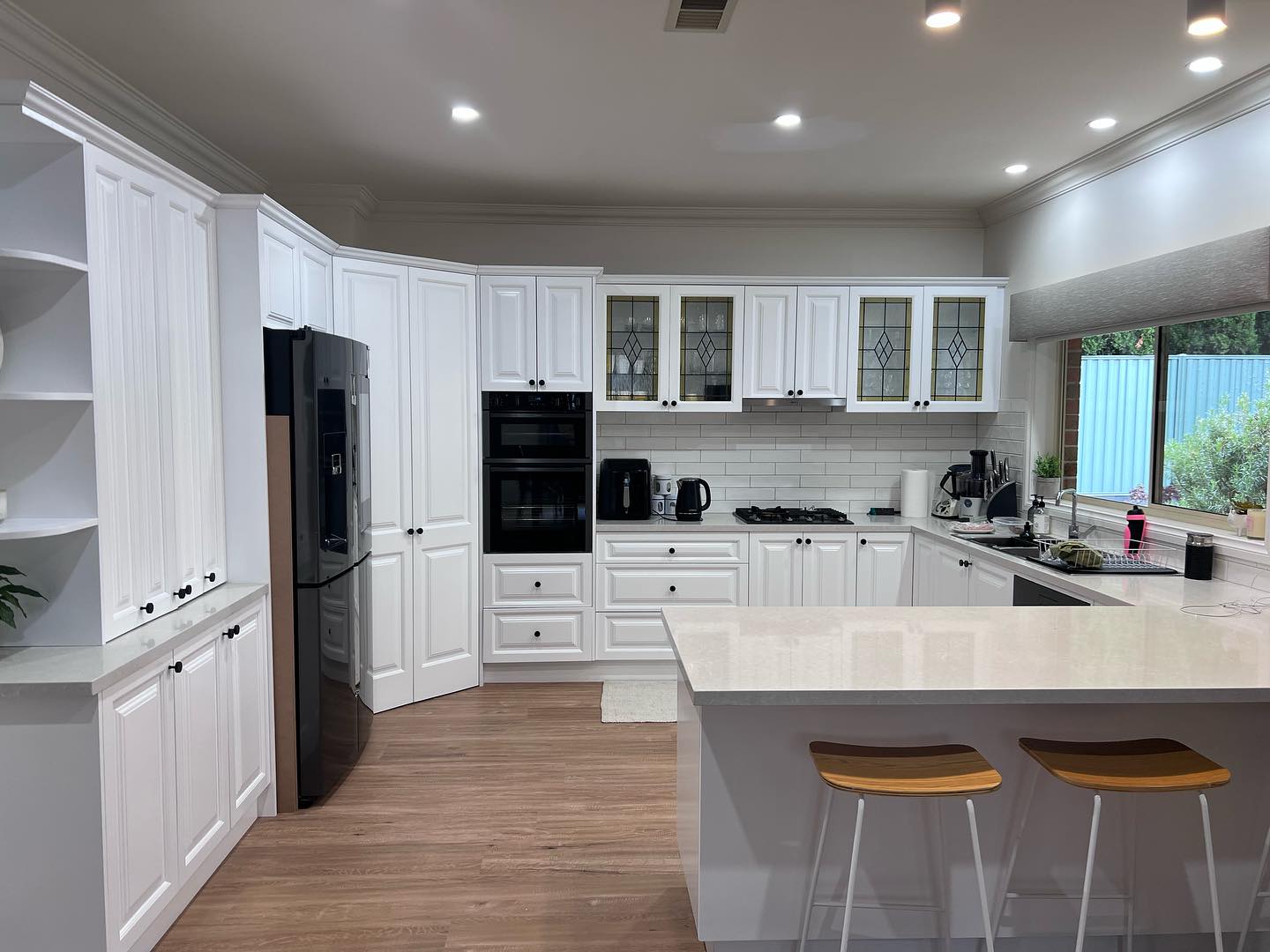 Modern kitchen with white cabinetry and light-colored countertop