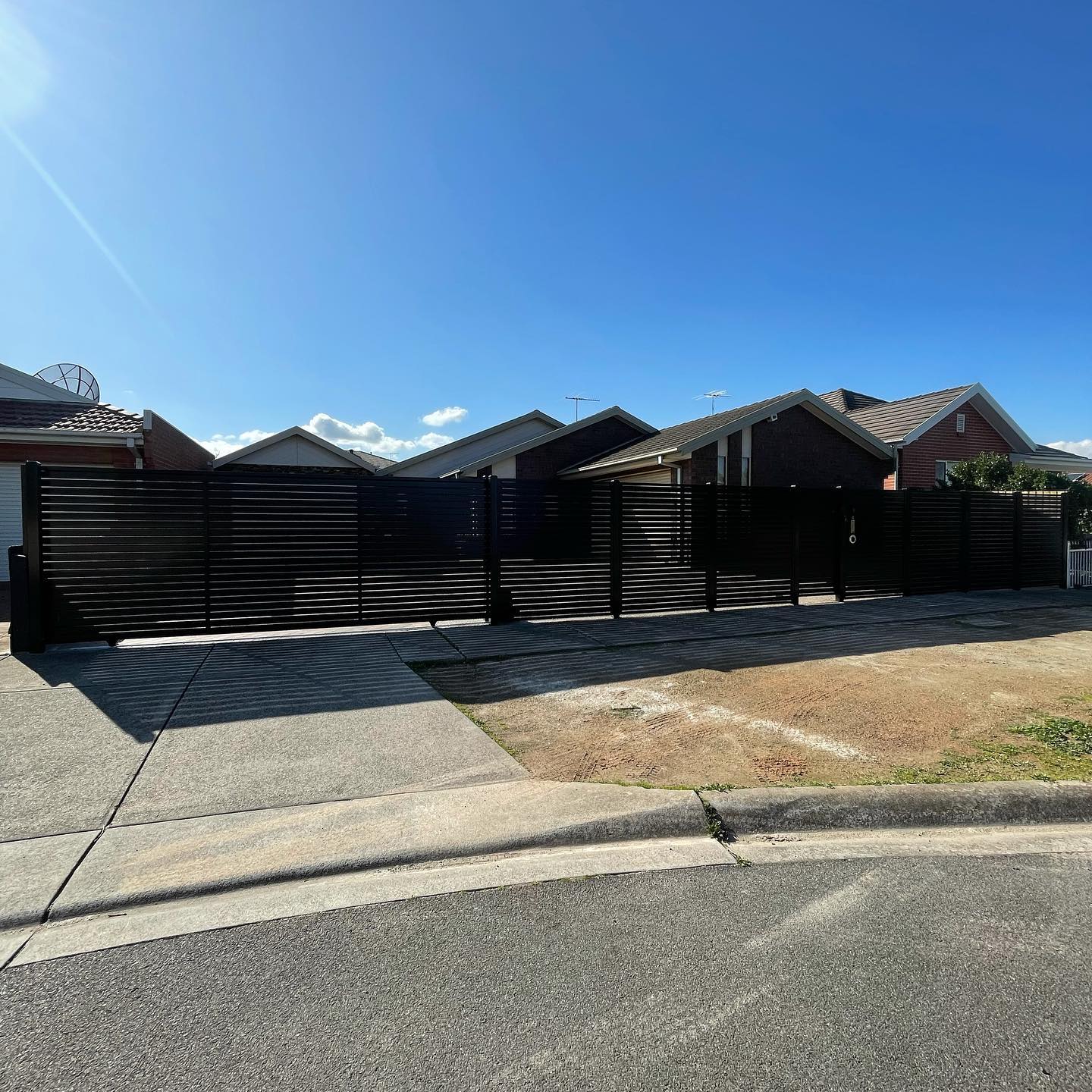 Closed sliding gate leading to residential property