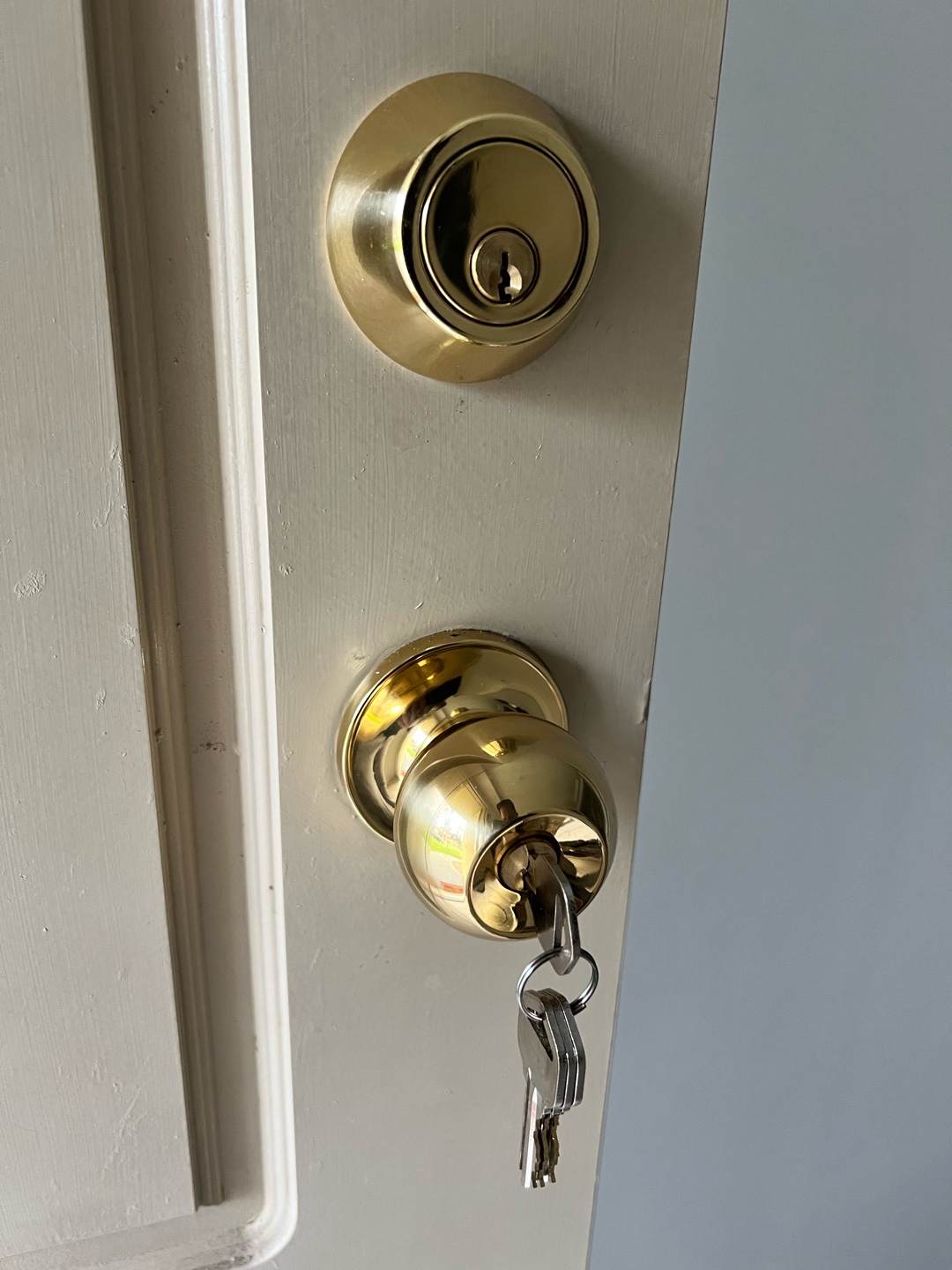 Completed door lock installation with polished brass locks