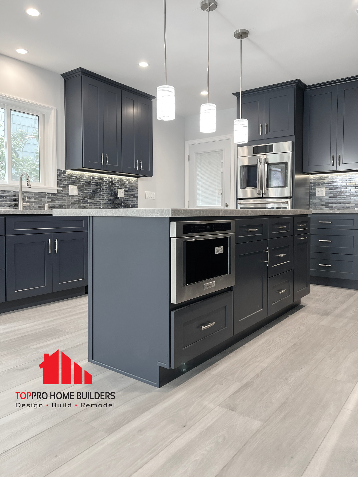 Modern kitchen with dark blue cabinets and central island