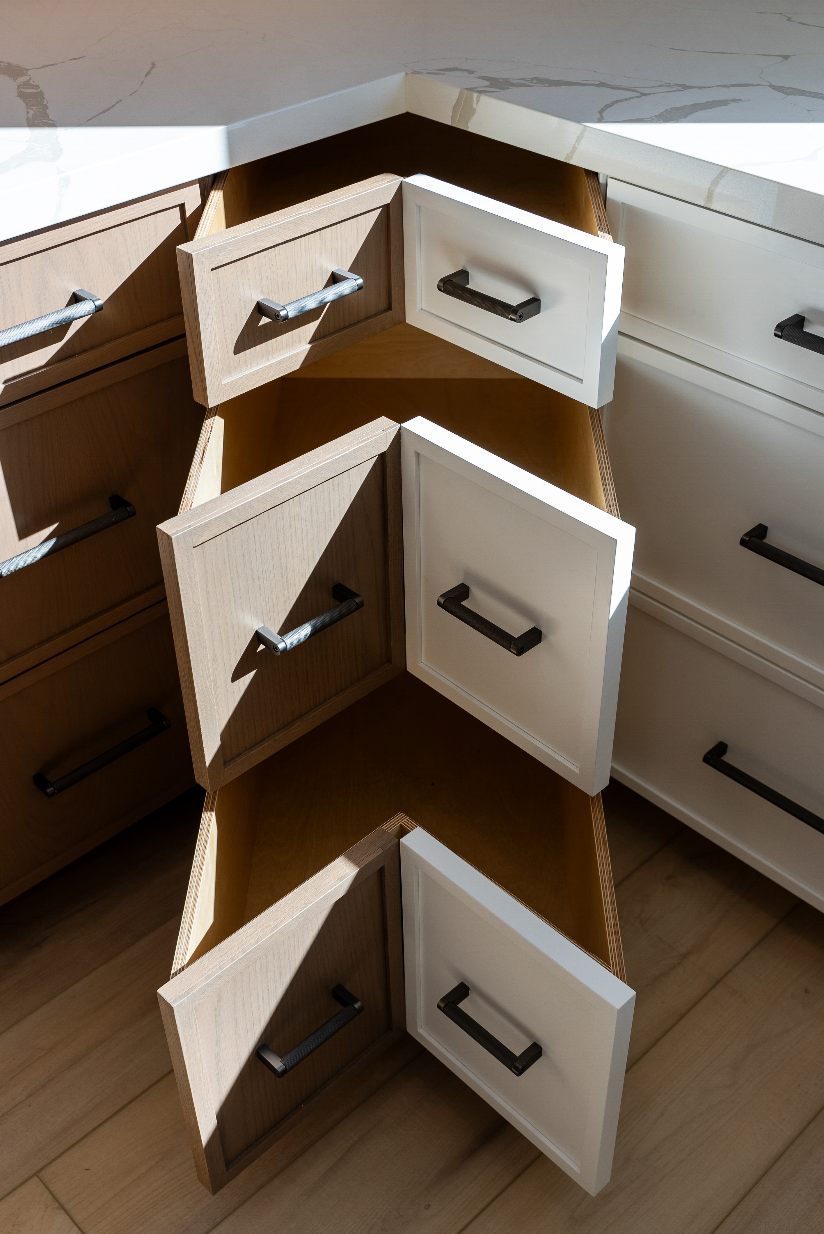 Corner cabinet with uniquely angled drawers