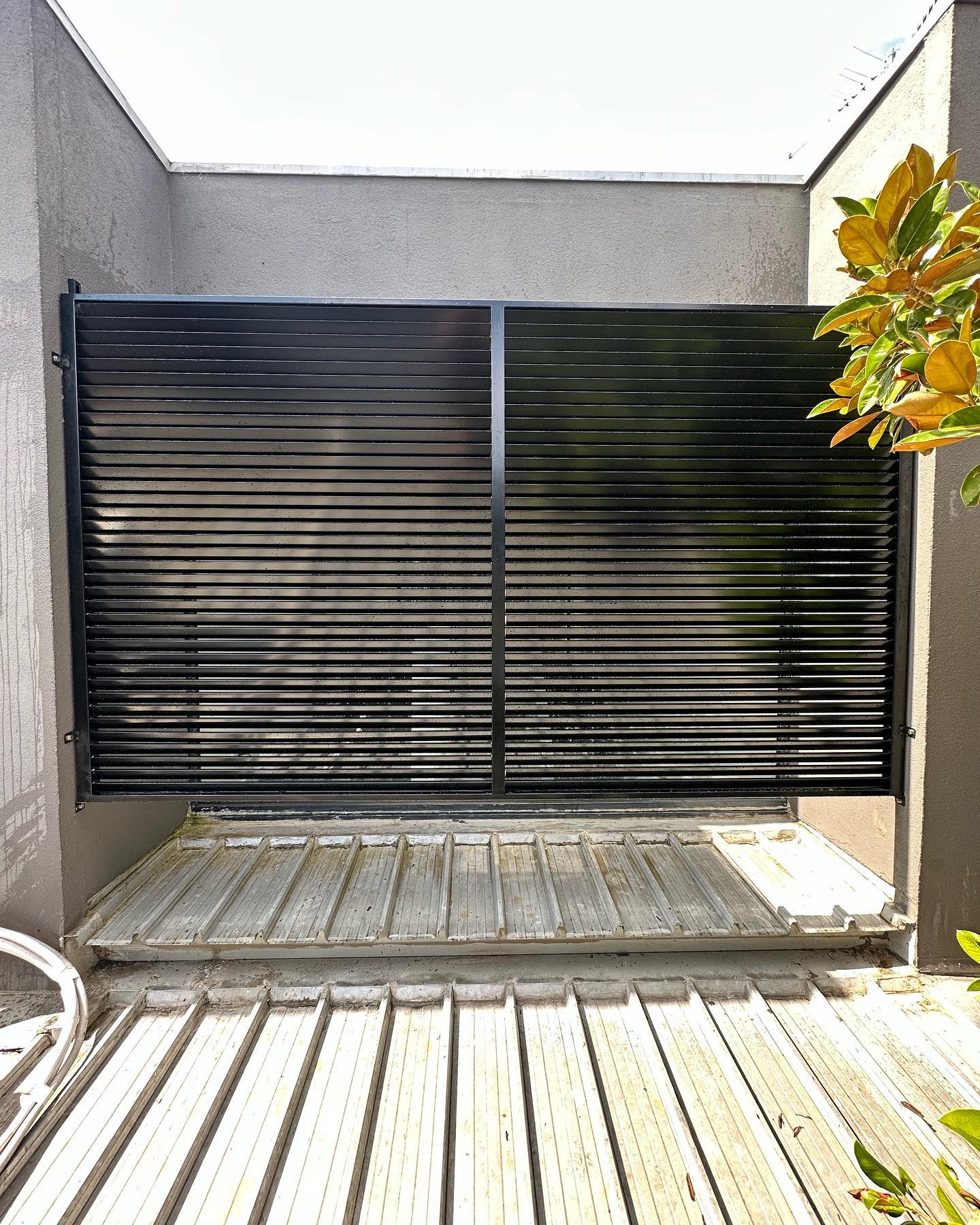 Custom slat fence gate in outdoor setting