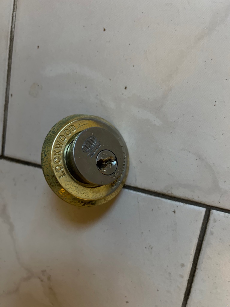 Replaced Lockwood lock barrel on tiled surface