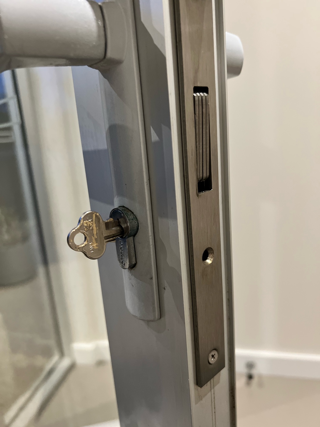 Close-up view of door lock mechanism with broken key inside