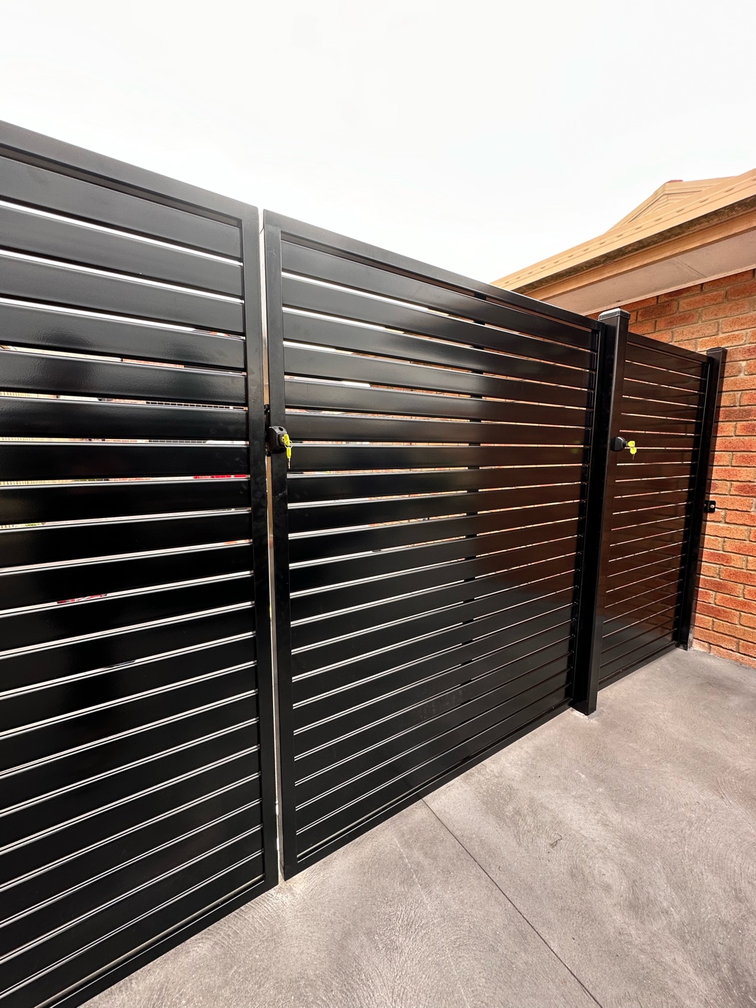 Black slat screen gates with locks