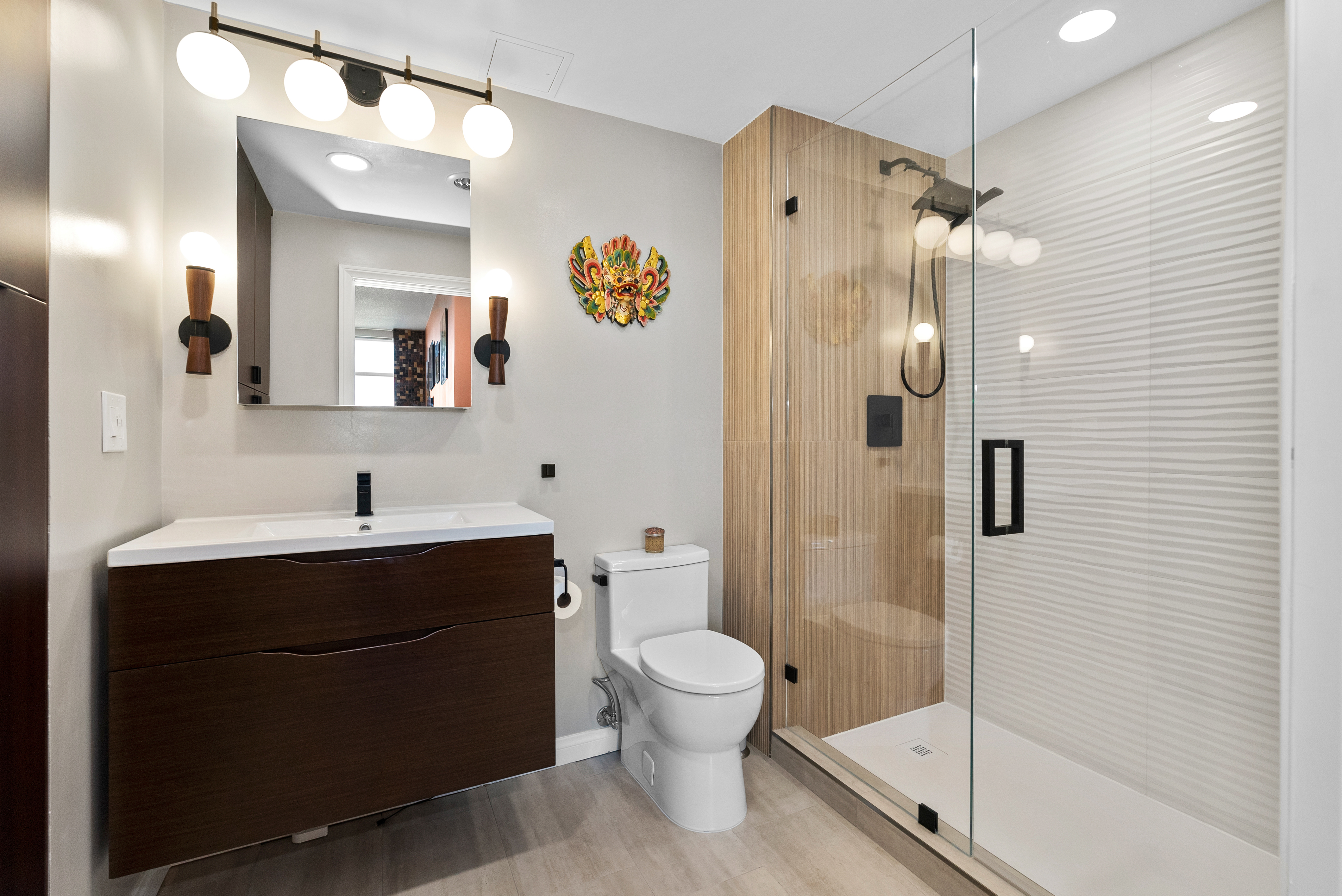 Modern bathroom featuring dark wood cabinetry and white countertop