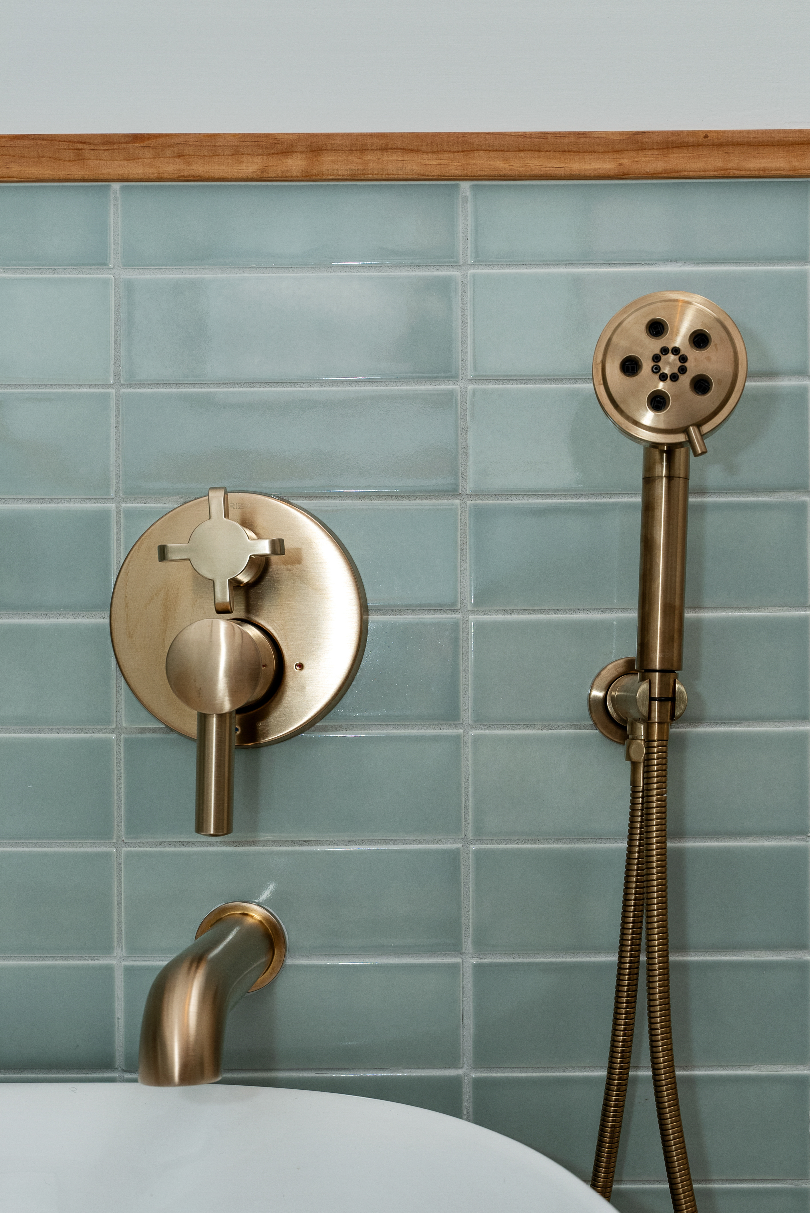 Modern bathroom wall tiles with brass fixtures