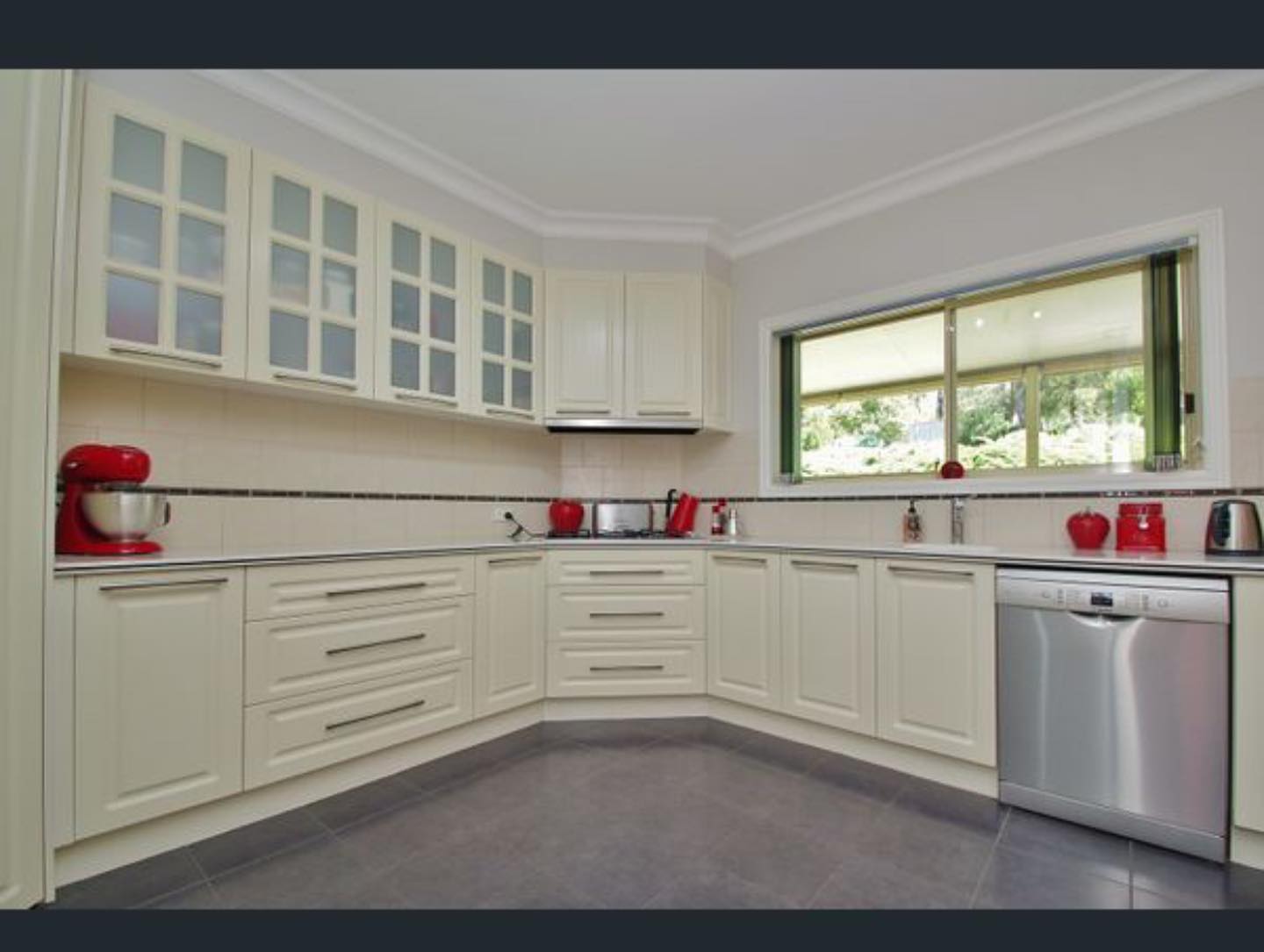 Cream-colored cabinetry after resurfacing