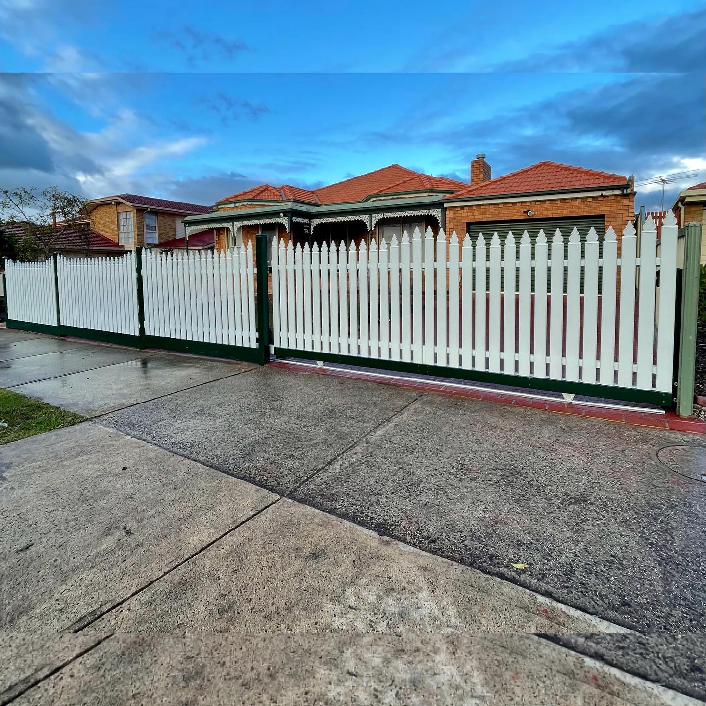 Residential area with white metal picket fence