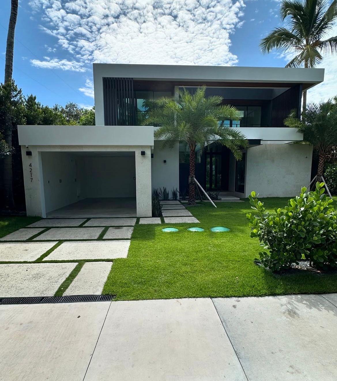 Modern two-story house with a flat roof and minimalist design