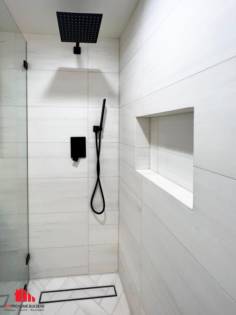 Modern shower area with white tiled walls