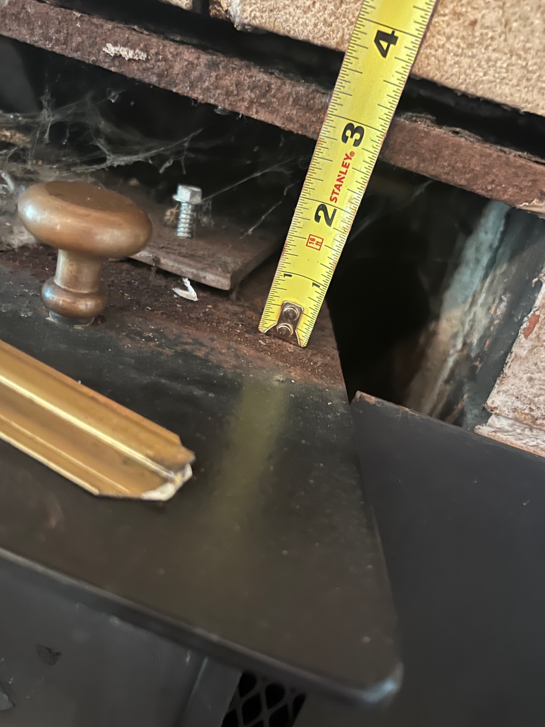 Close-up of measuring tape inside fireplace