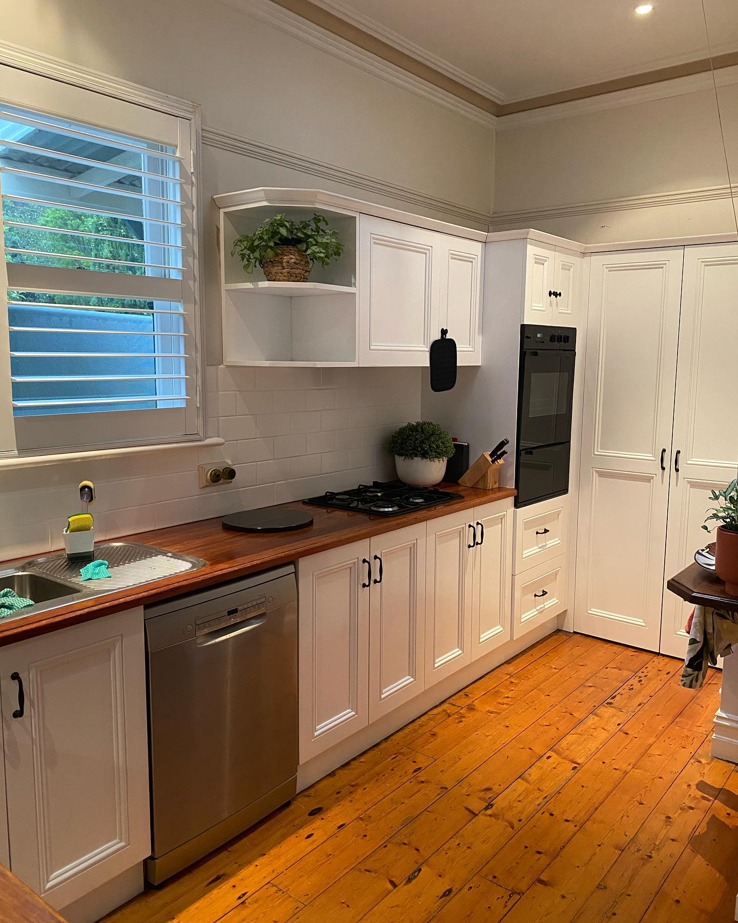 Clean white cabinetry with black handles