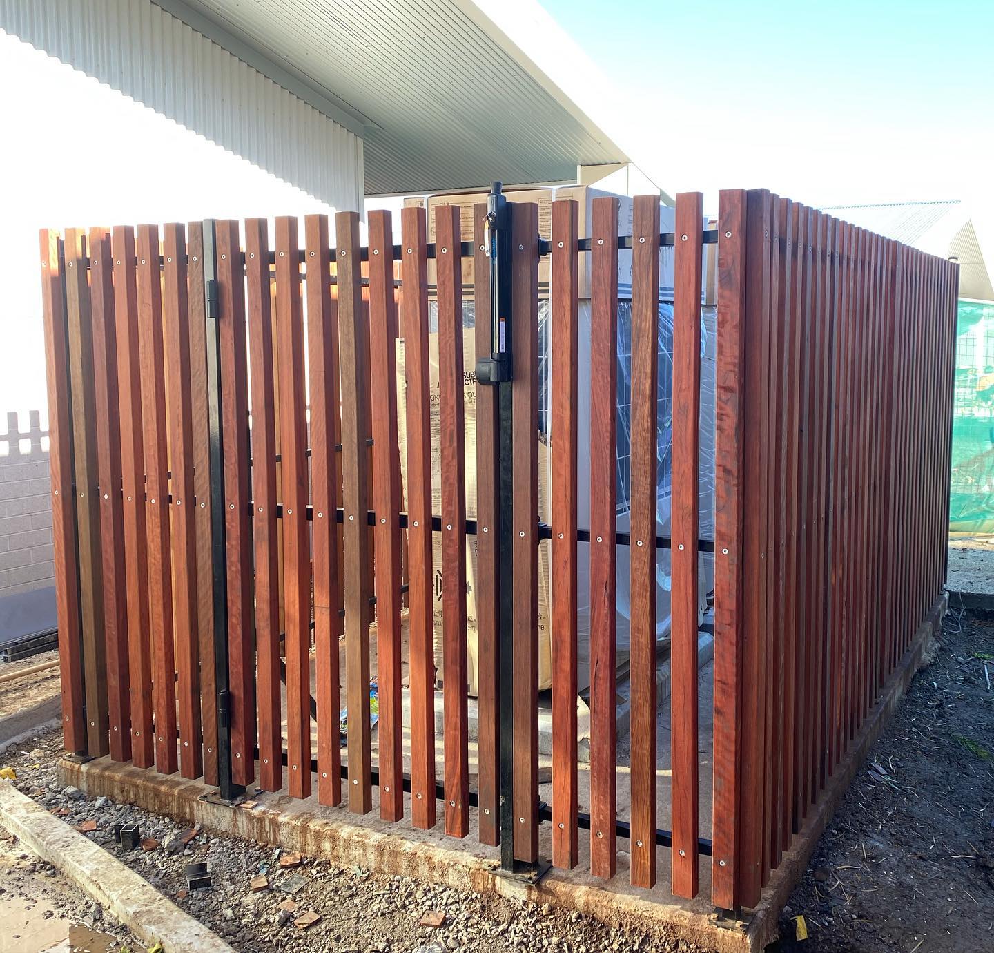 Spotted Gum Battens on Satin Black Frame: Custom Installation in Niddrie 2 Vertical spotted gum battens on satin black frame