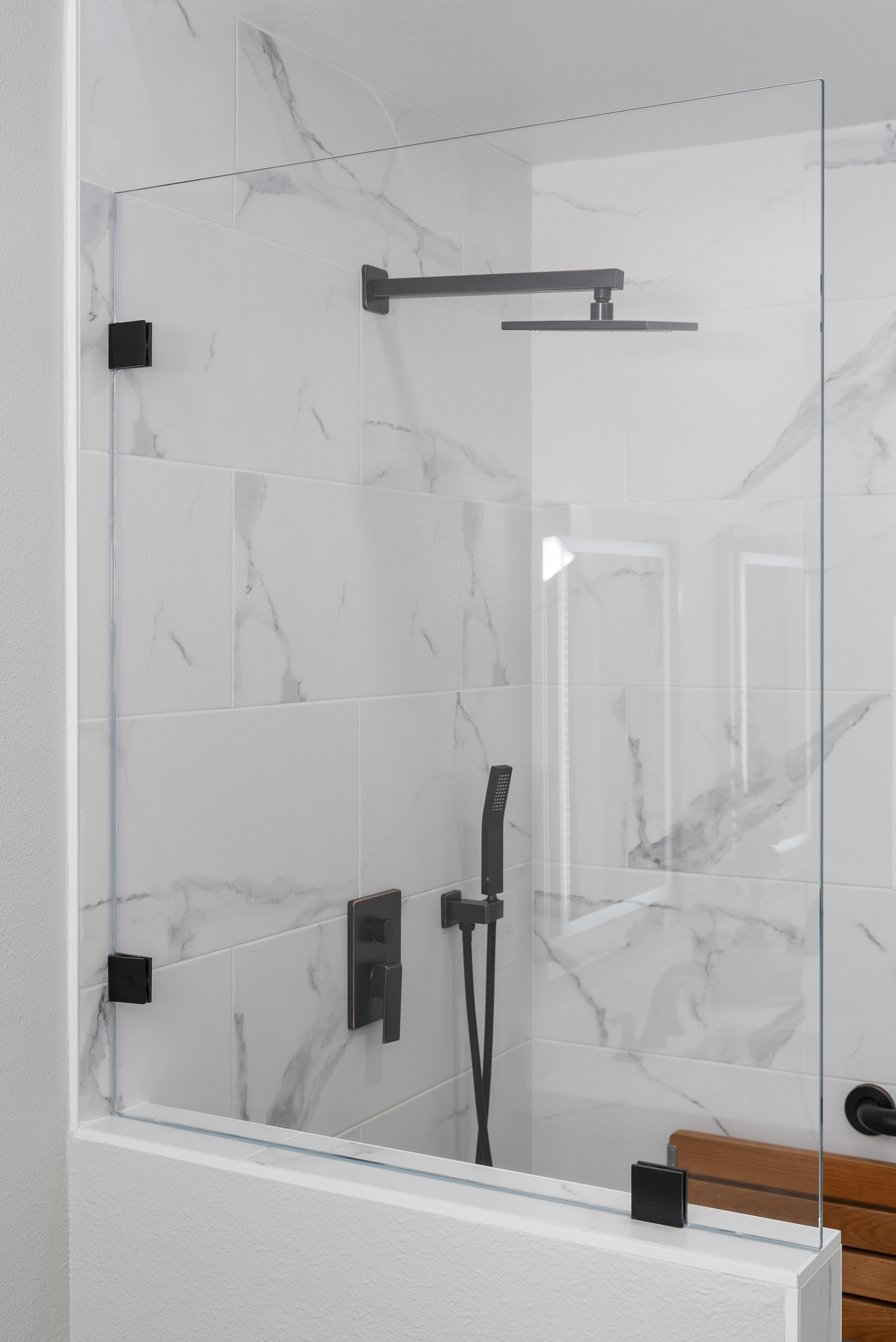 Modern shower area with marble-patterned tiles