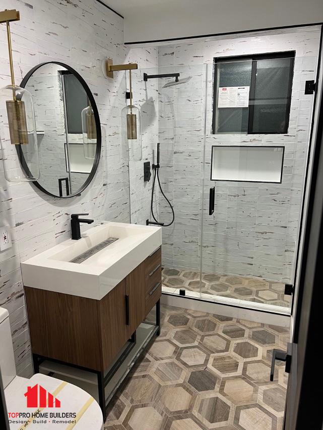 Modern bathroom remodel featuring glass-enclosed shower and elegant fixtures