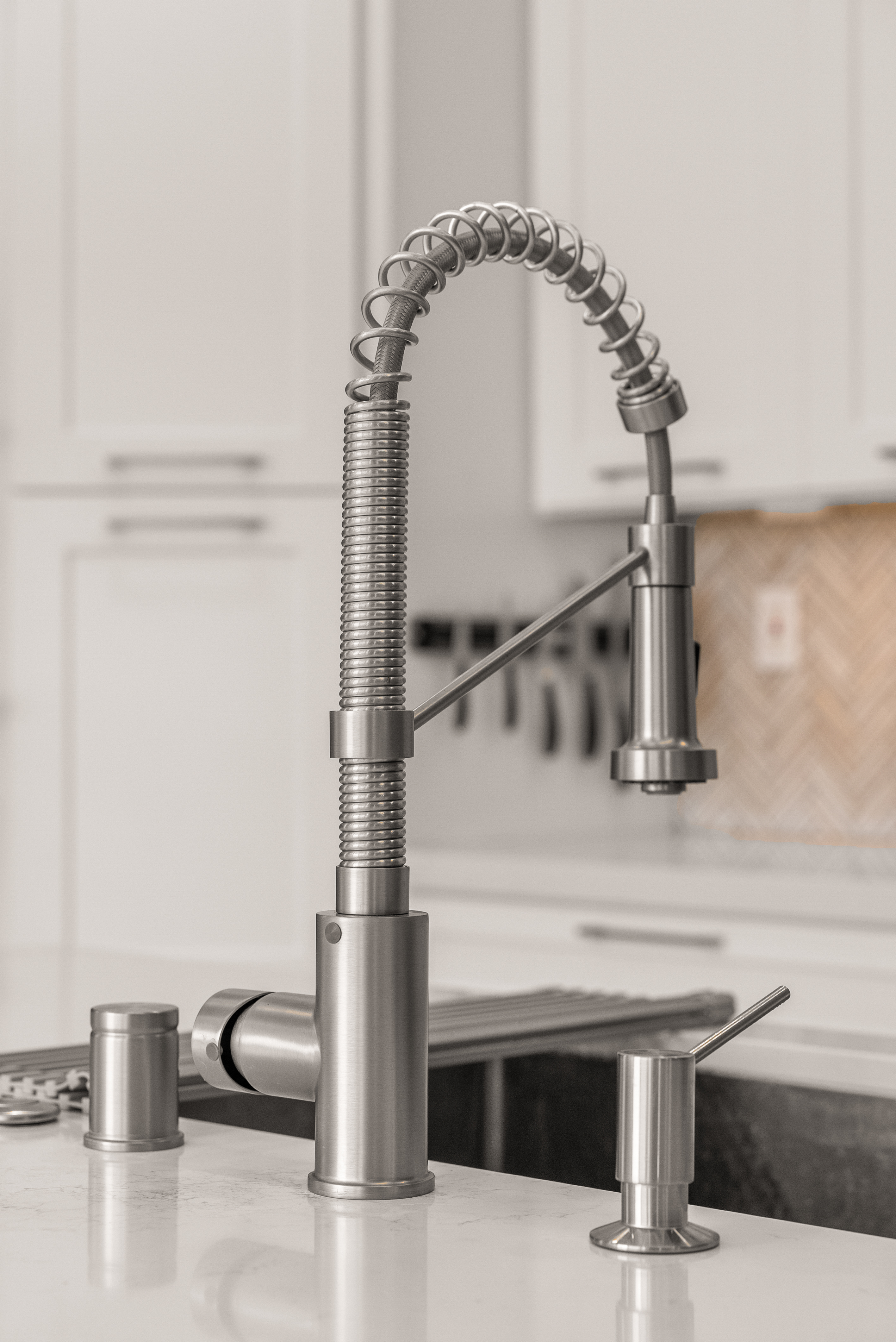 Modern stainless steel faucet mounted on quartz countertop