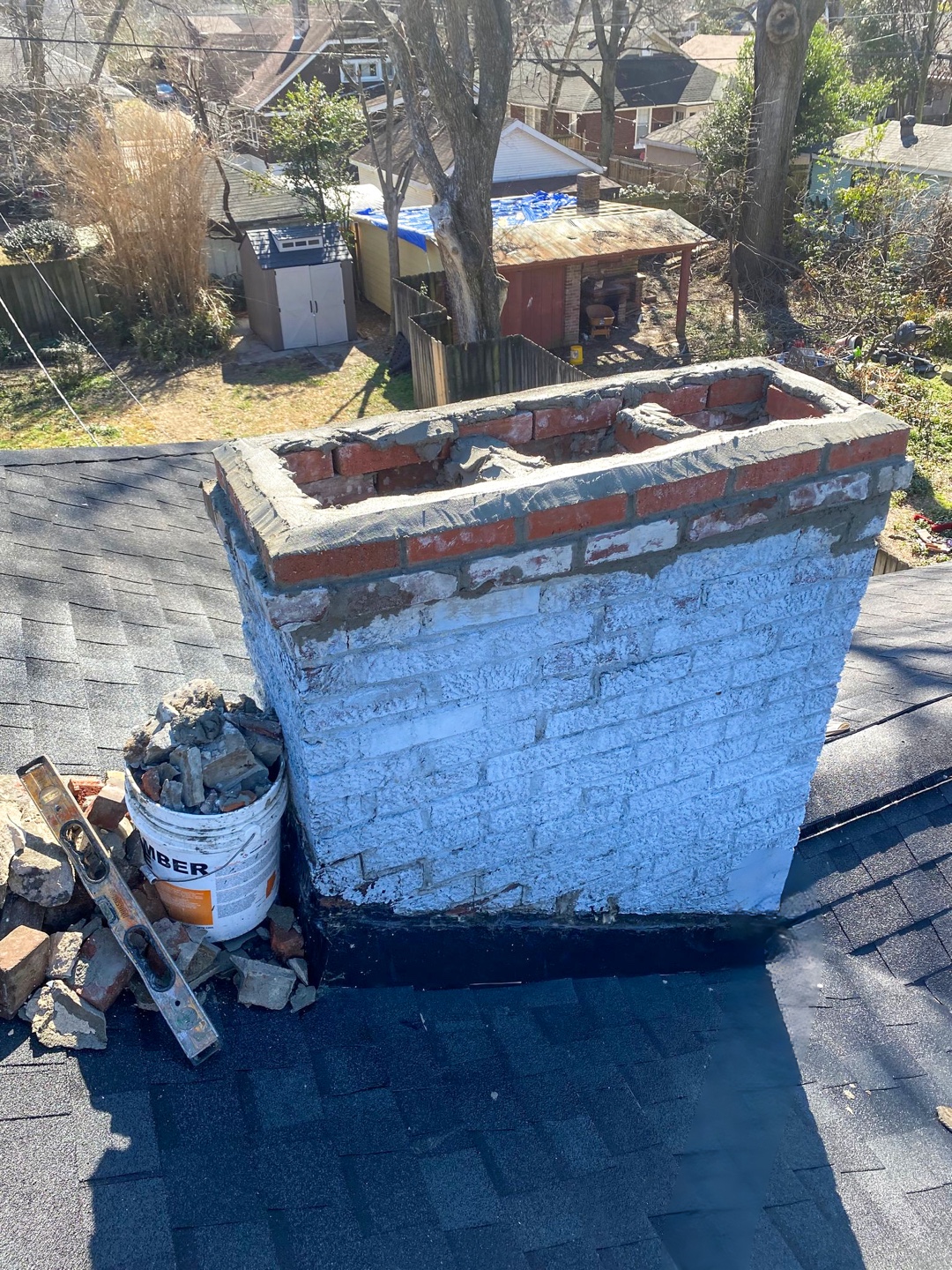 Partially deconstructed chimney showing visible flue liners