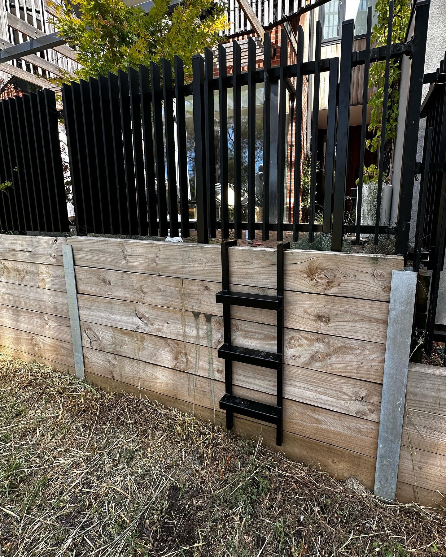 Creating Secure Park Access for a Northcote Townhouse 5 Removable black metal ladder attached to wooden wall