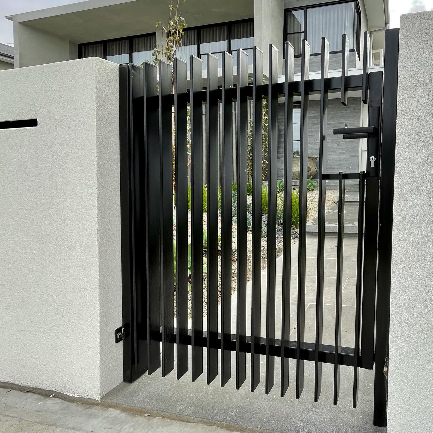 Elegant Satin Black Fencing with Twin Auto Sliders for Altona North Townhouses 3 Black satin-coated metal gate with vertical blades
