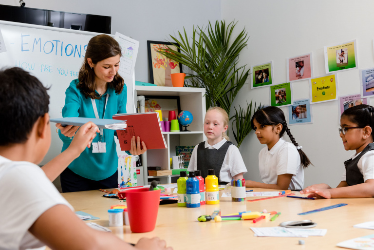 A female teacher engaging with her students in a classroom setting