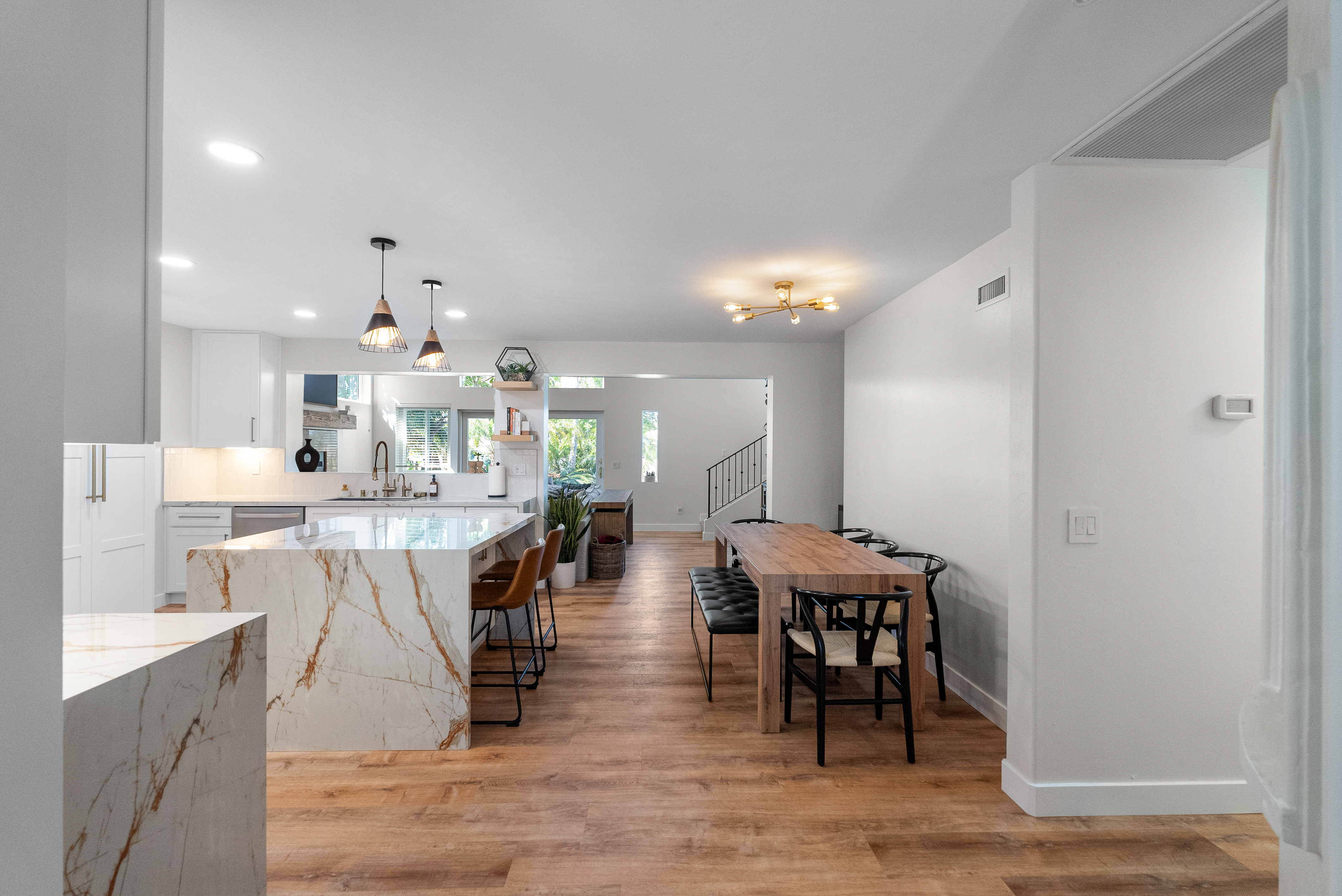 Modern kitchen with white cabinetry and marble countertop