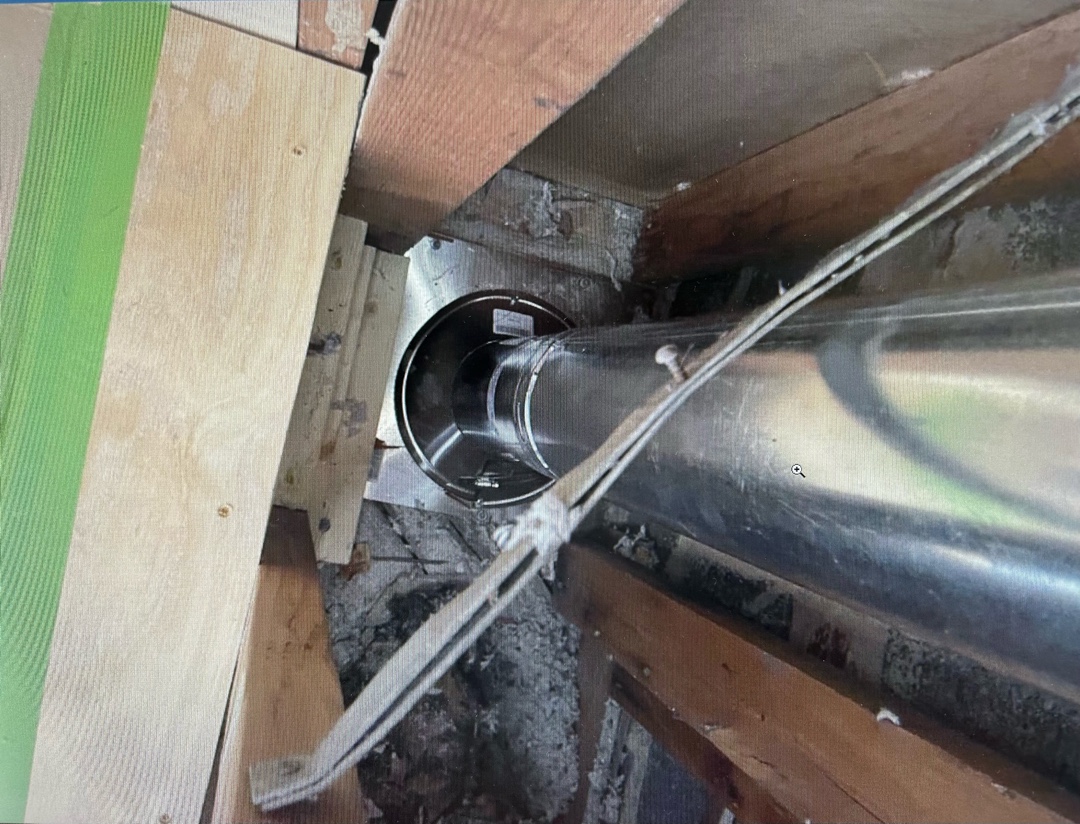 Newly installed shiny metal B-Vent on roof