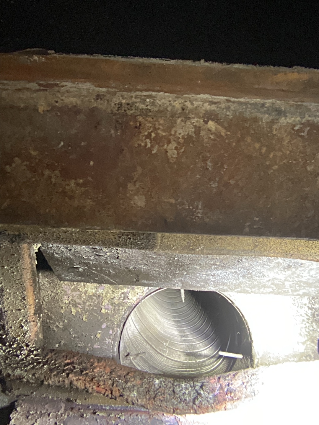 Cylindrical metal pipe showing signs of wear