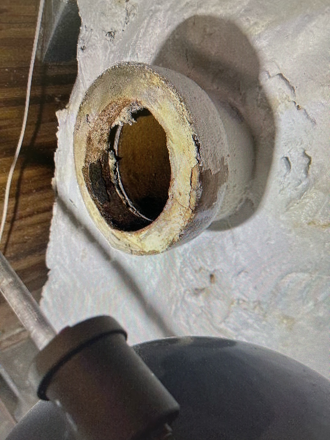 Close-up view of deteriorated vent pipe