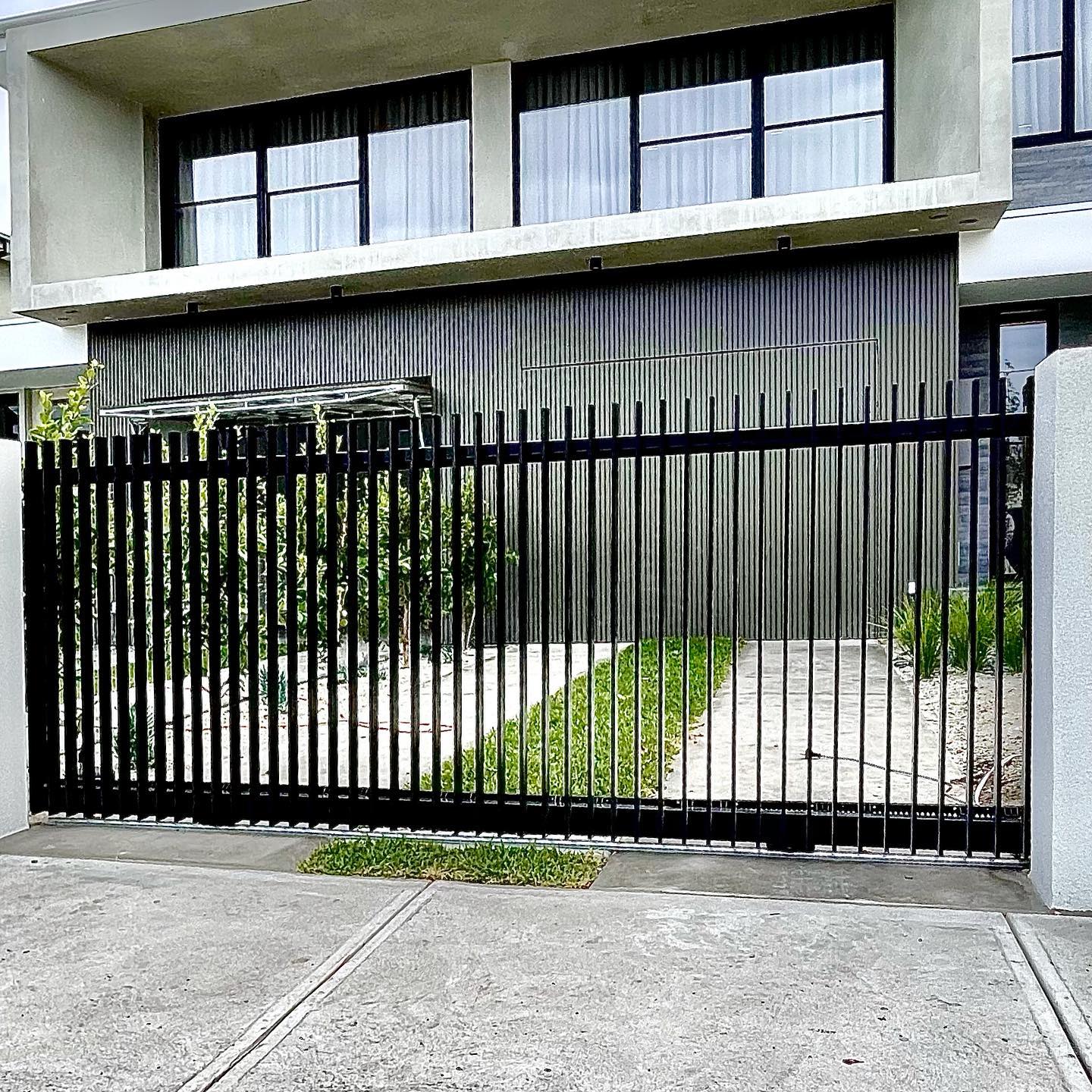 Elegant Satin Black Fencing with Twin Auto Sliders for Altona North Townhouses 4 Modern architectural design with satin black fencing