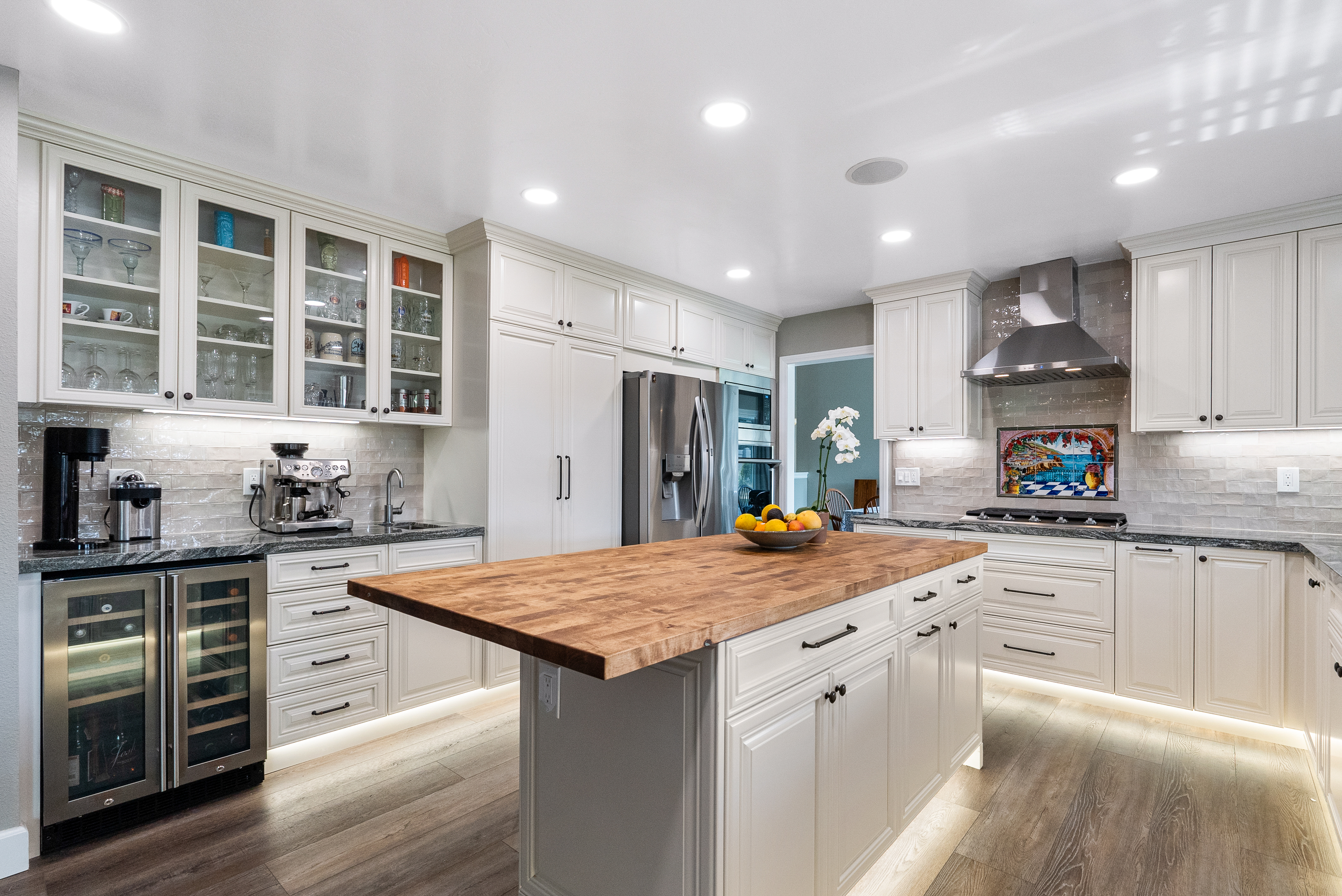 Modern kitchen with white cabinetry and large wooden island