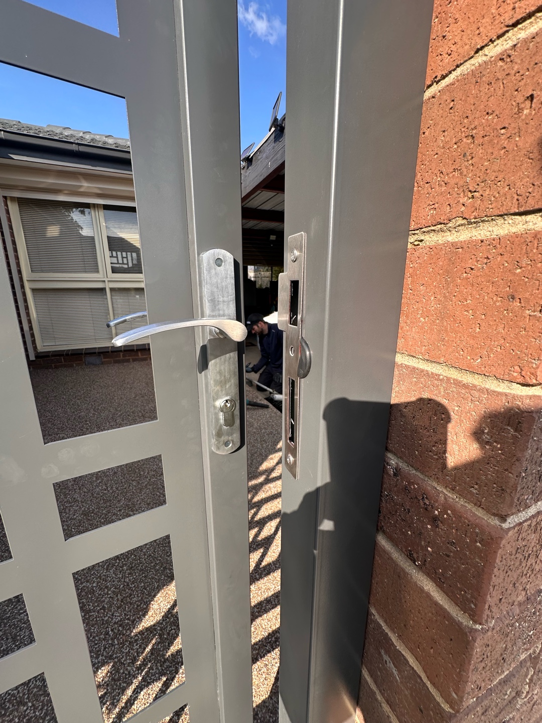 Partially open steel door revealing outdoor area